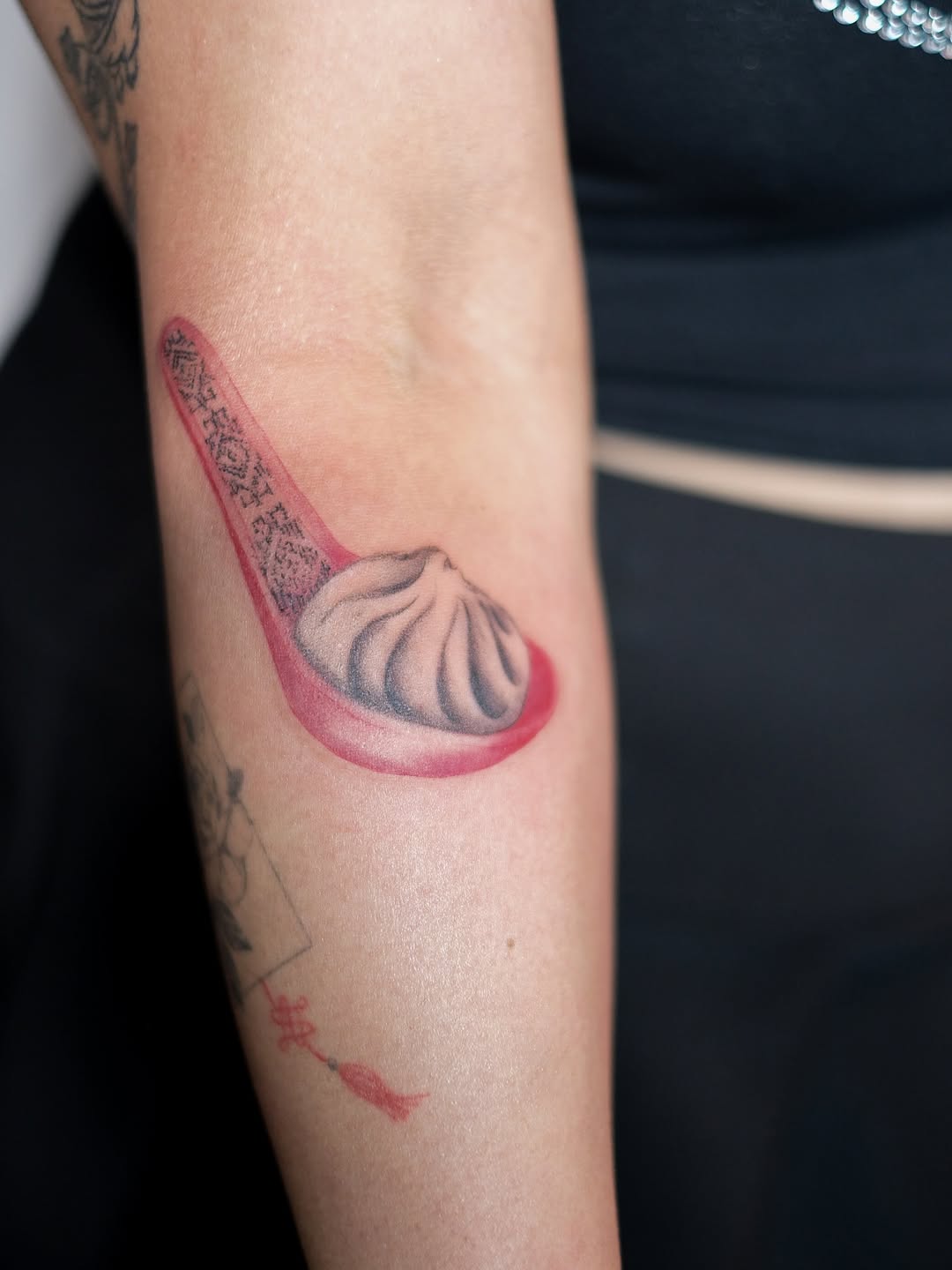 Dumpling on a spoon minimalist tattoo on the forearm by Jinz