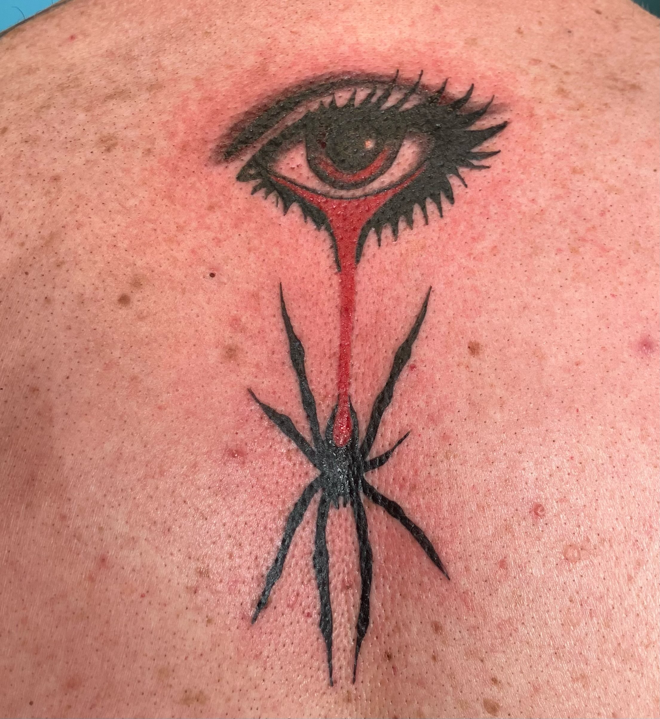Eye with spider dark realism tattoo on the back by Bryant Johnson