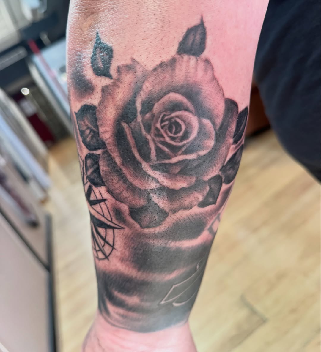 Rose black and grey tattoo on the forearm by spikecitytattoo