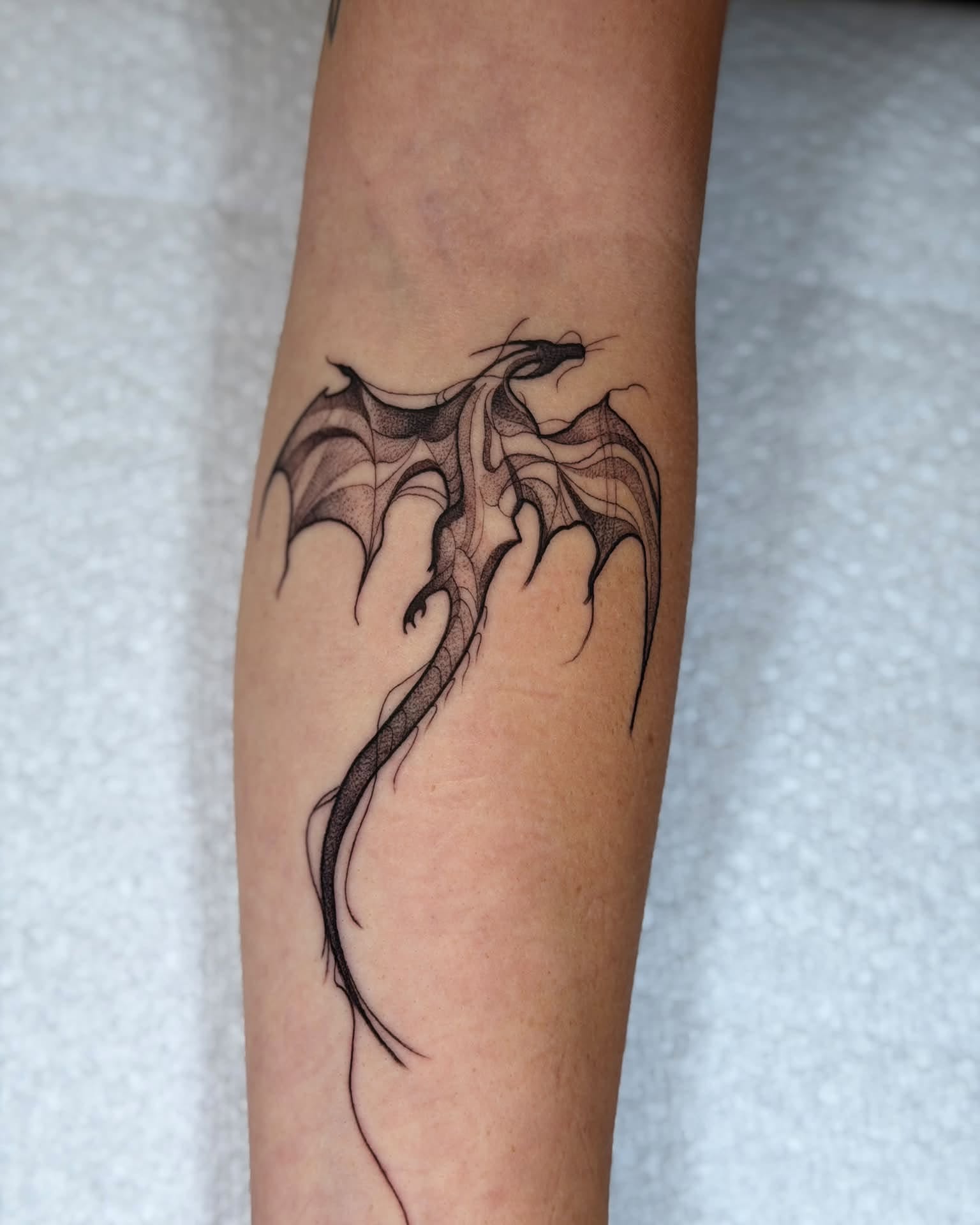 Dragon dotwork tattoo on the forearm by Chad Meado