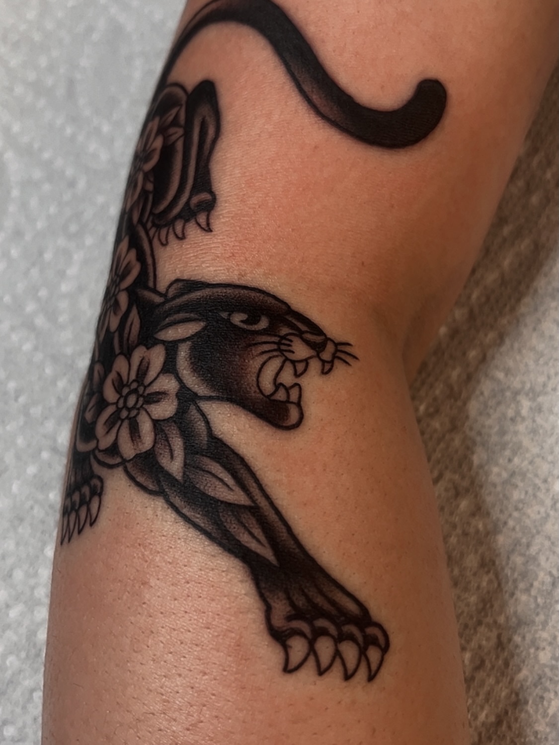 Panther and flowers black and grey tattoo on the forearm by Las Vegas Tattoo Artist