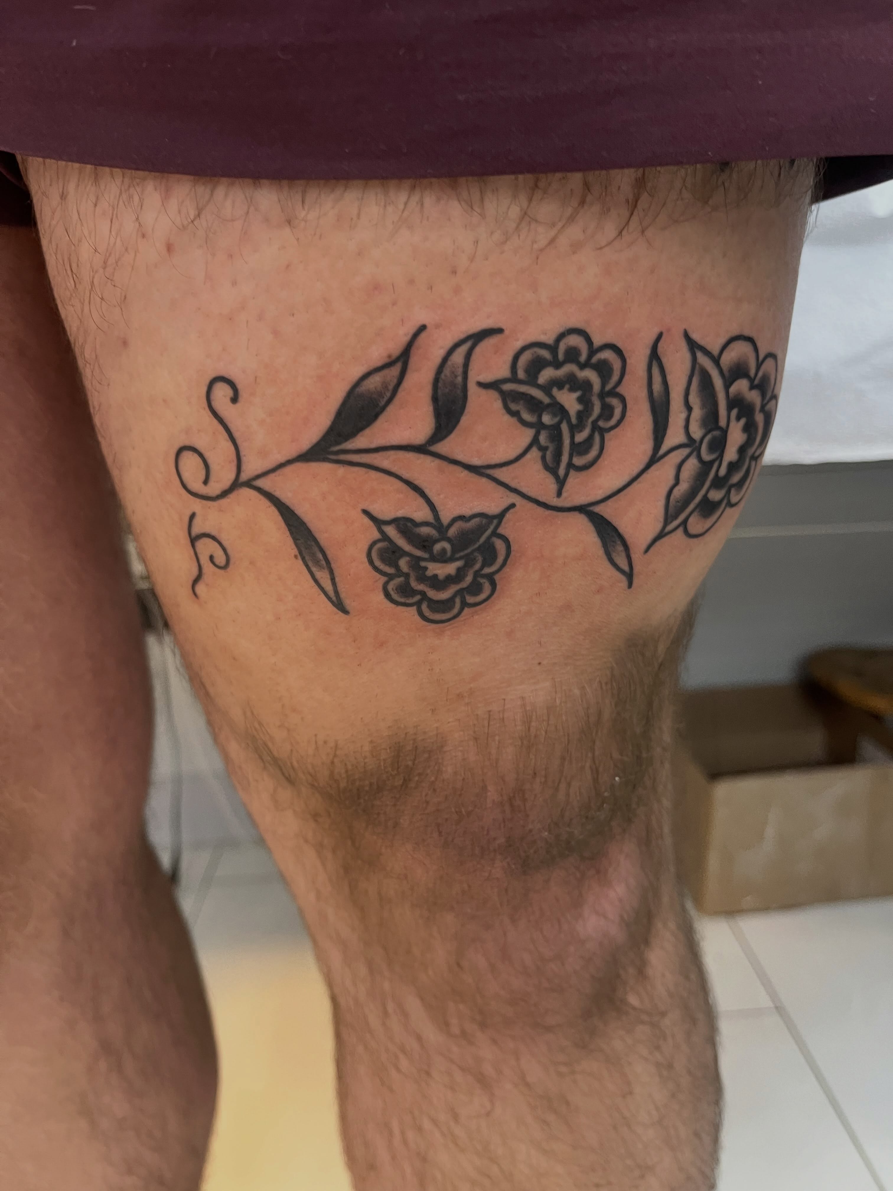 Floral vine black and grey tattoo on the thigh by Sour Tattoo, Somerville, Massachusetts