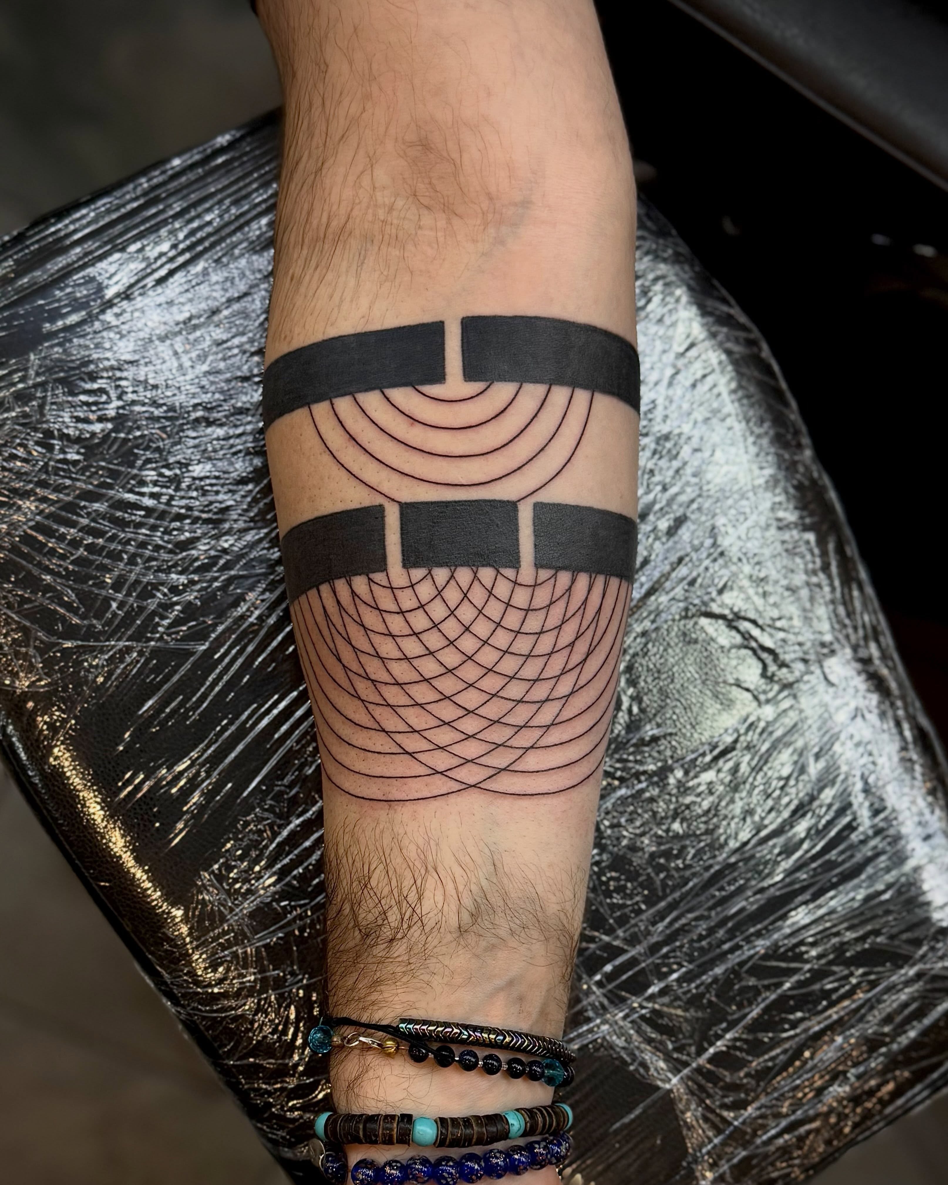 Geometric pattern geometric tattoo on the forearm by Ashley Kayser