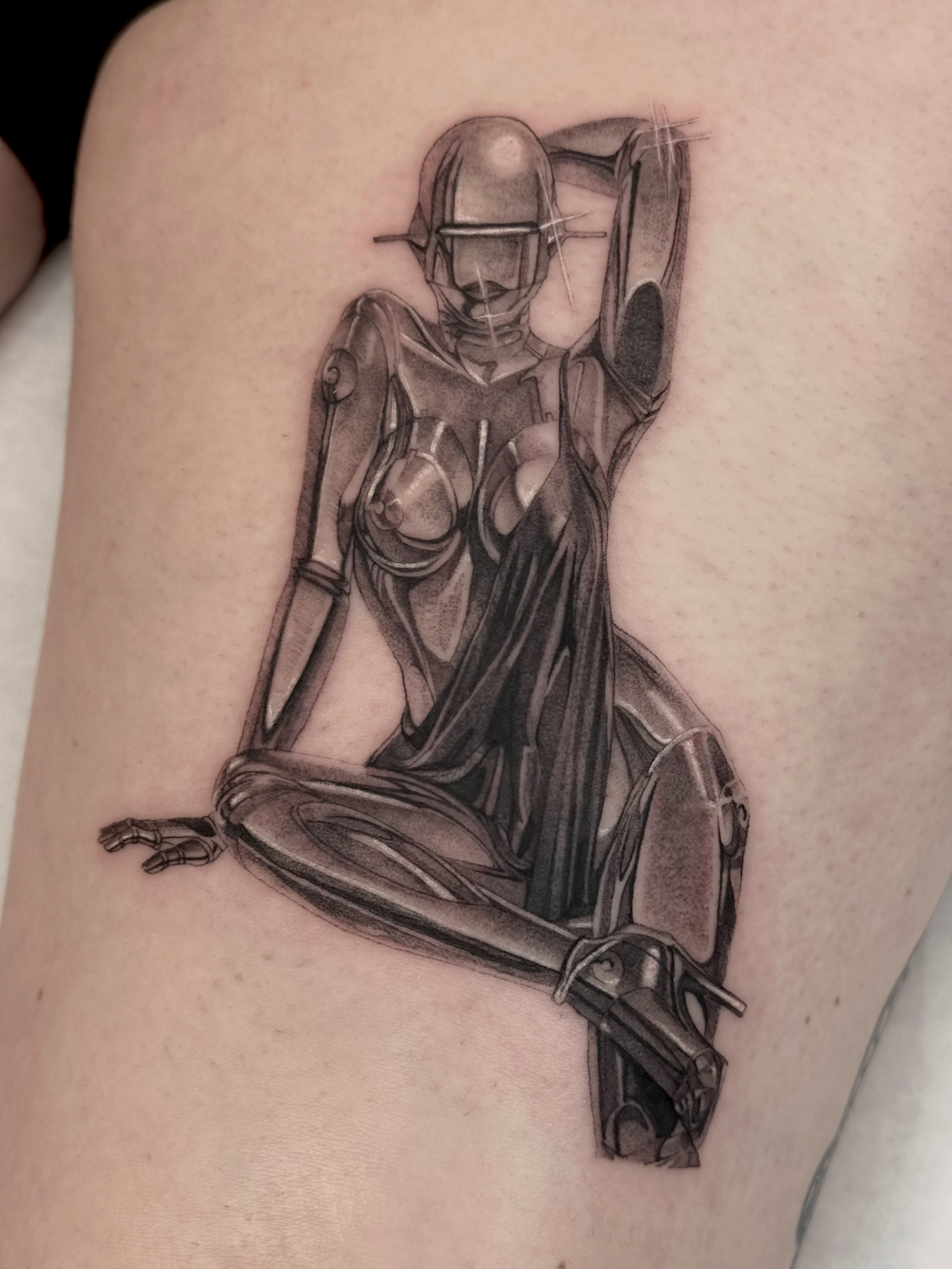 Android woman realism tattoo on the thigh by Em Krieg