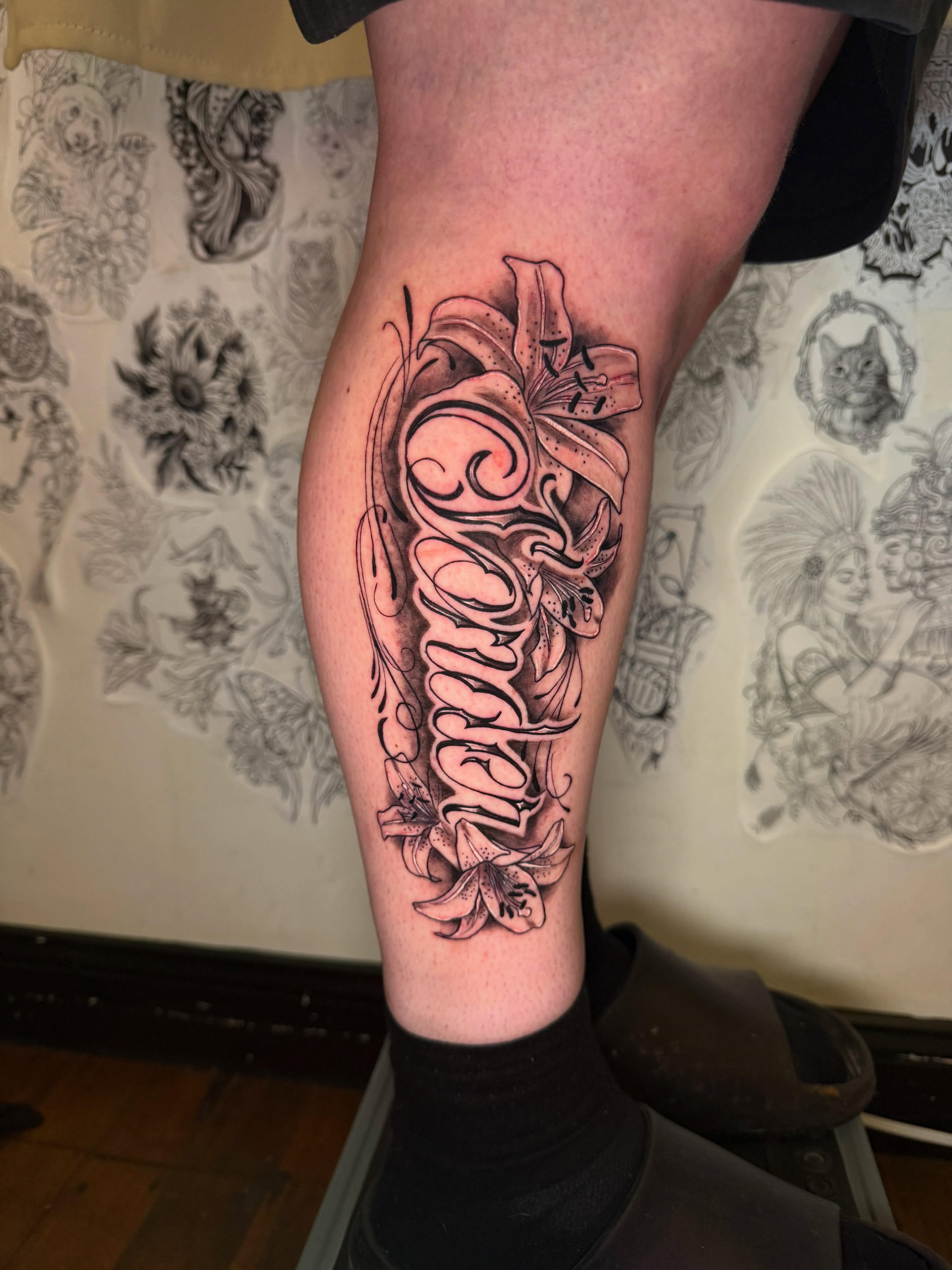 Lily and script ornamental tattoo on the calf by ❈°binx°❈