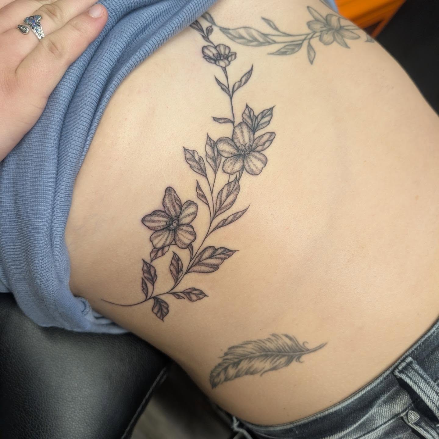 Flower vine black and grey tattoo on the ribs by Talia Zula, Loveland, Ohio