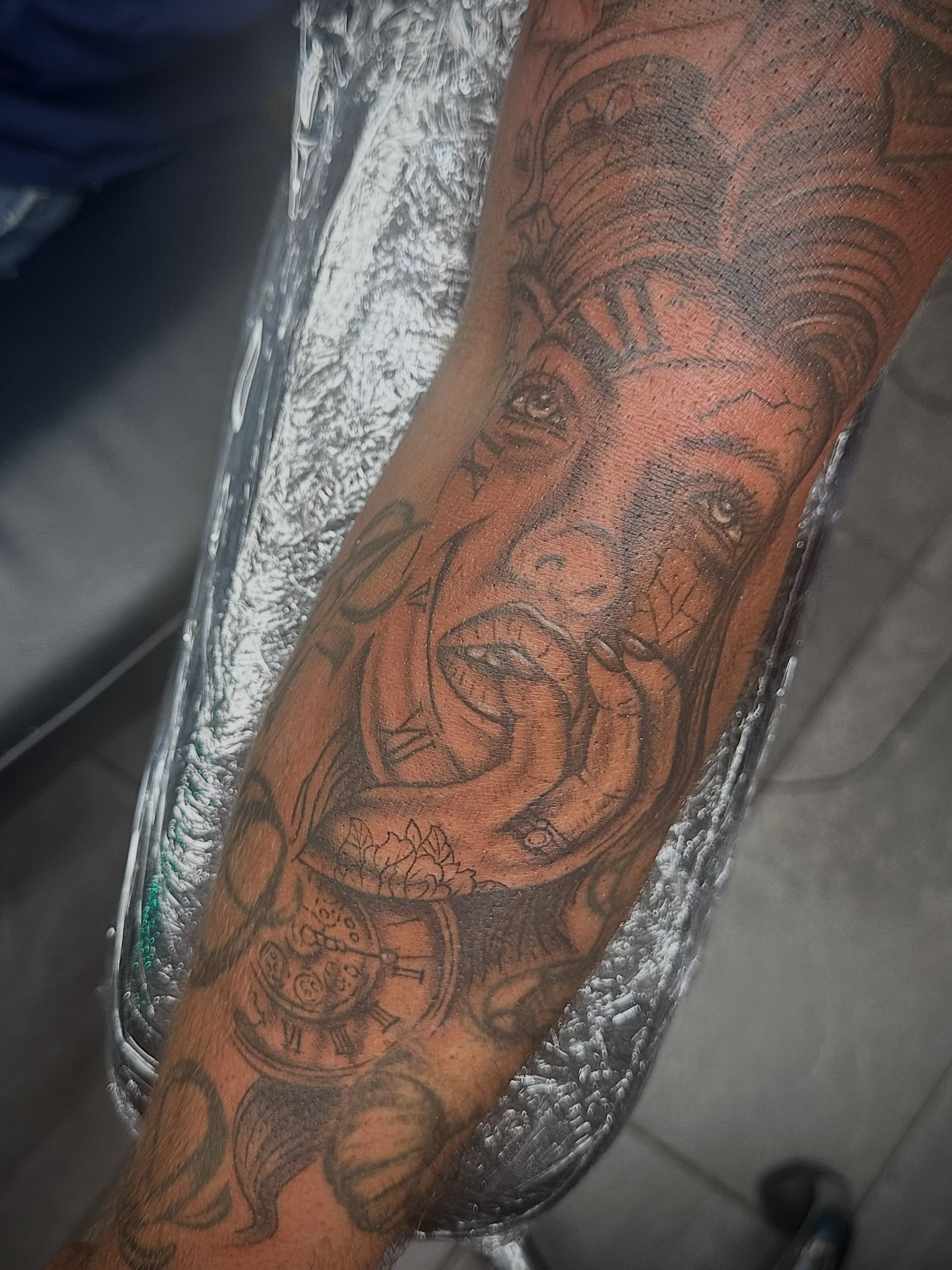 Woman with snake realism tattoo on the forearm by Mikaila Jean