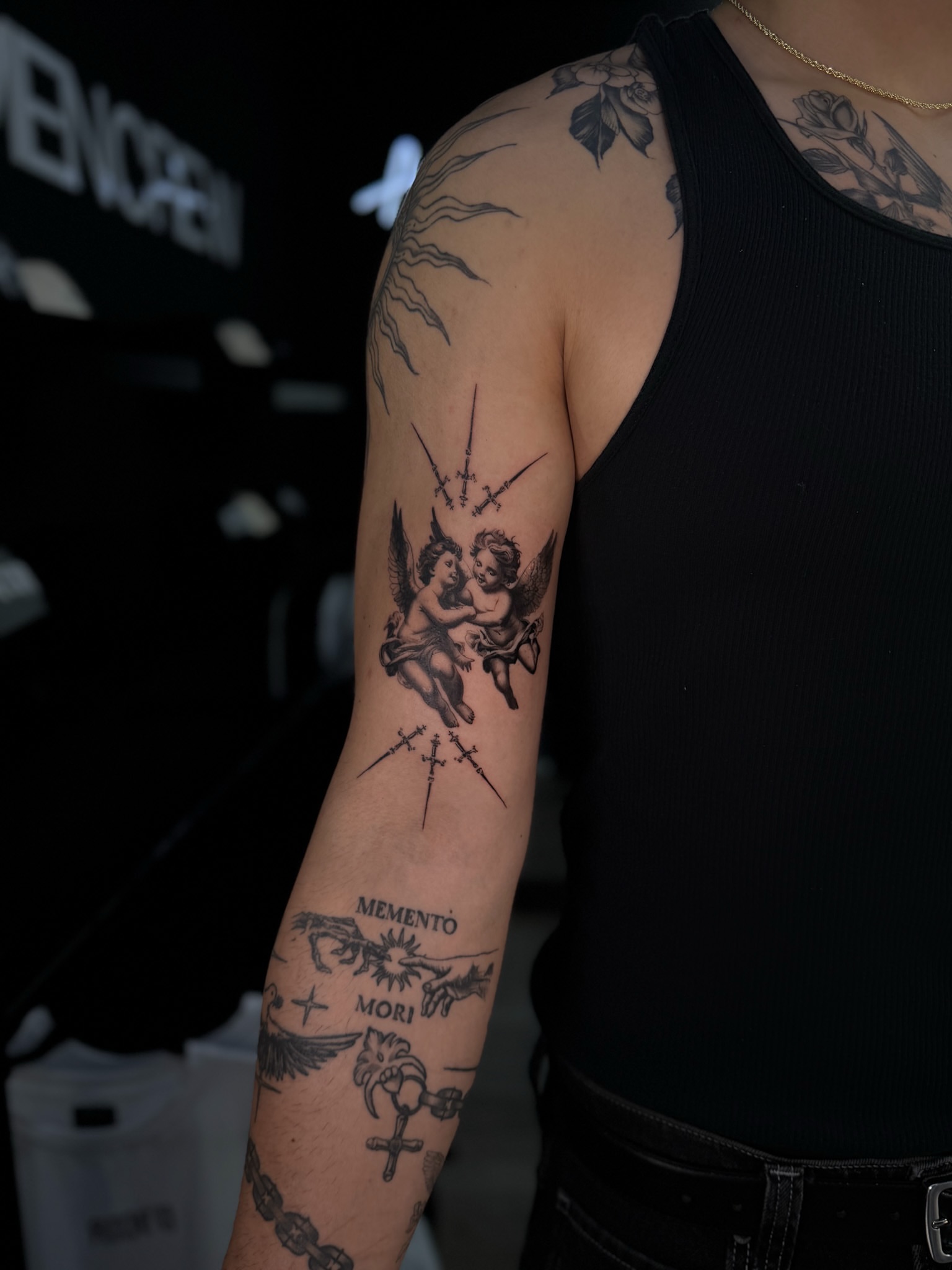 Cherubs and crosses black and grey tattoo on the forearm by Elijah Cosme, Miami, Florida