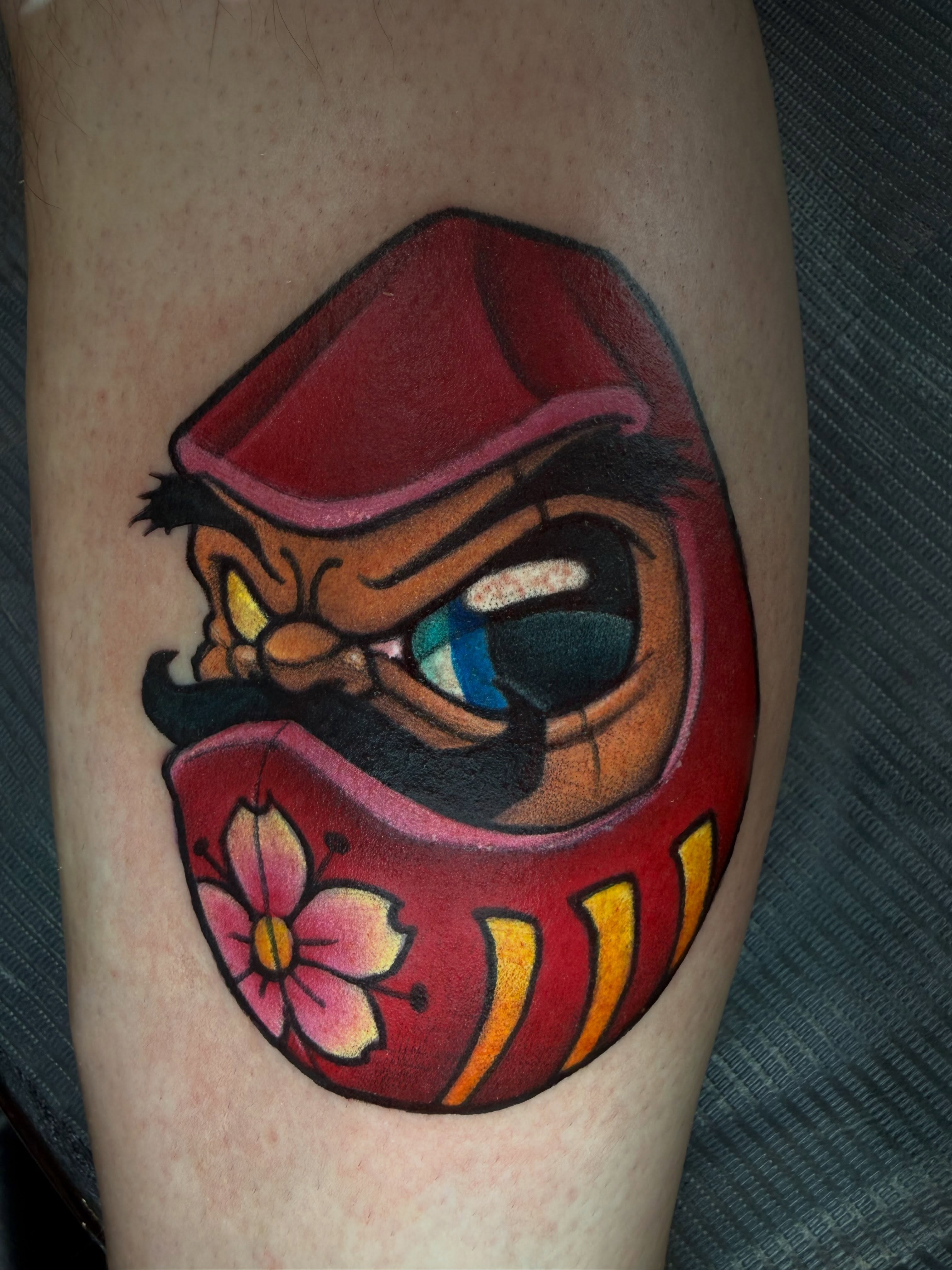 Angry mask American traditional tattoo on the forearm by Jime Litwalk