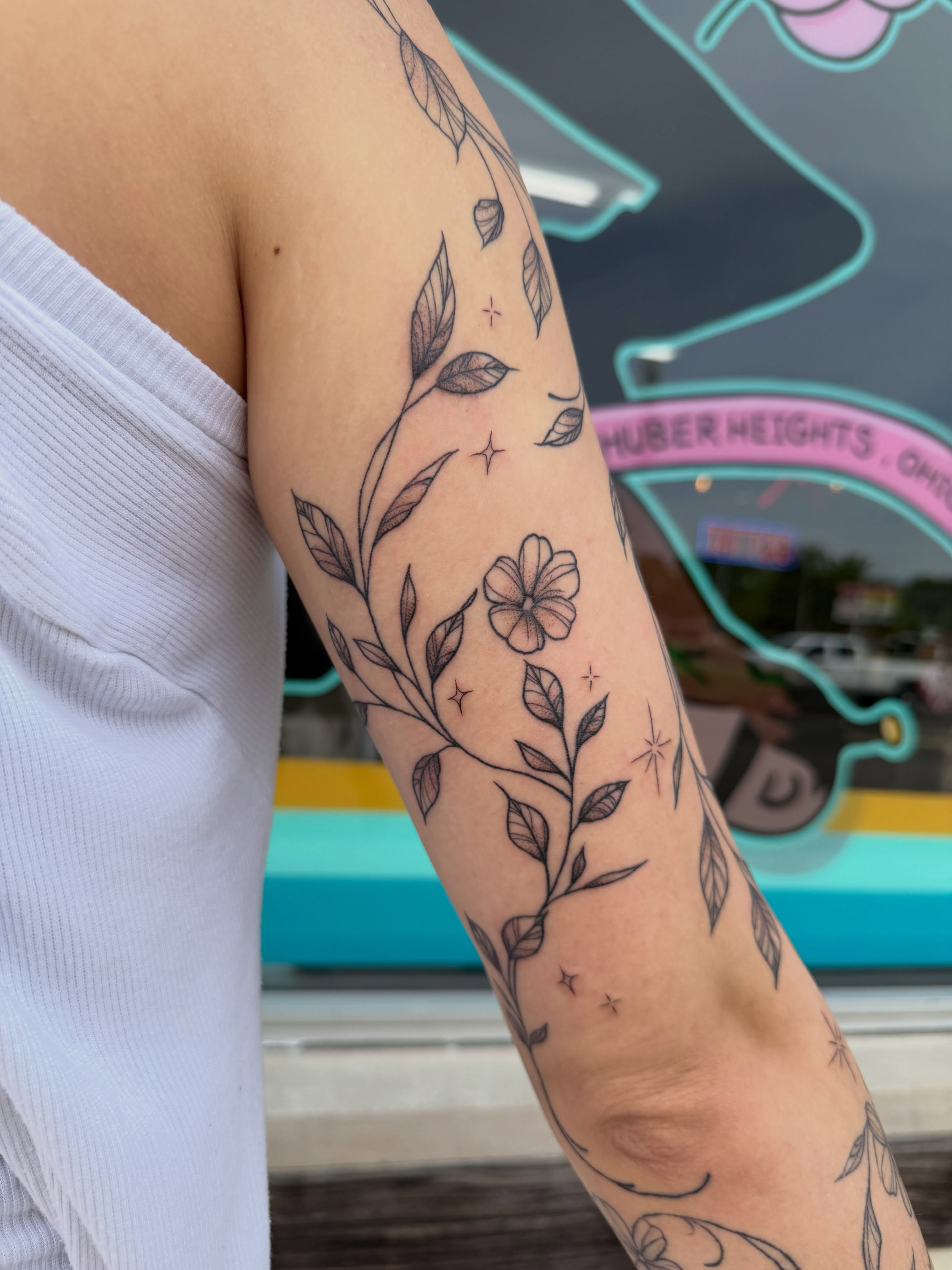 Floral vine fine line tattoo on the forearm by 𝕯𝖆𝖓𝖎