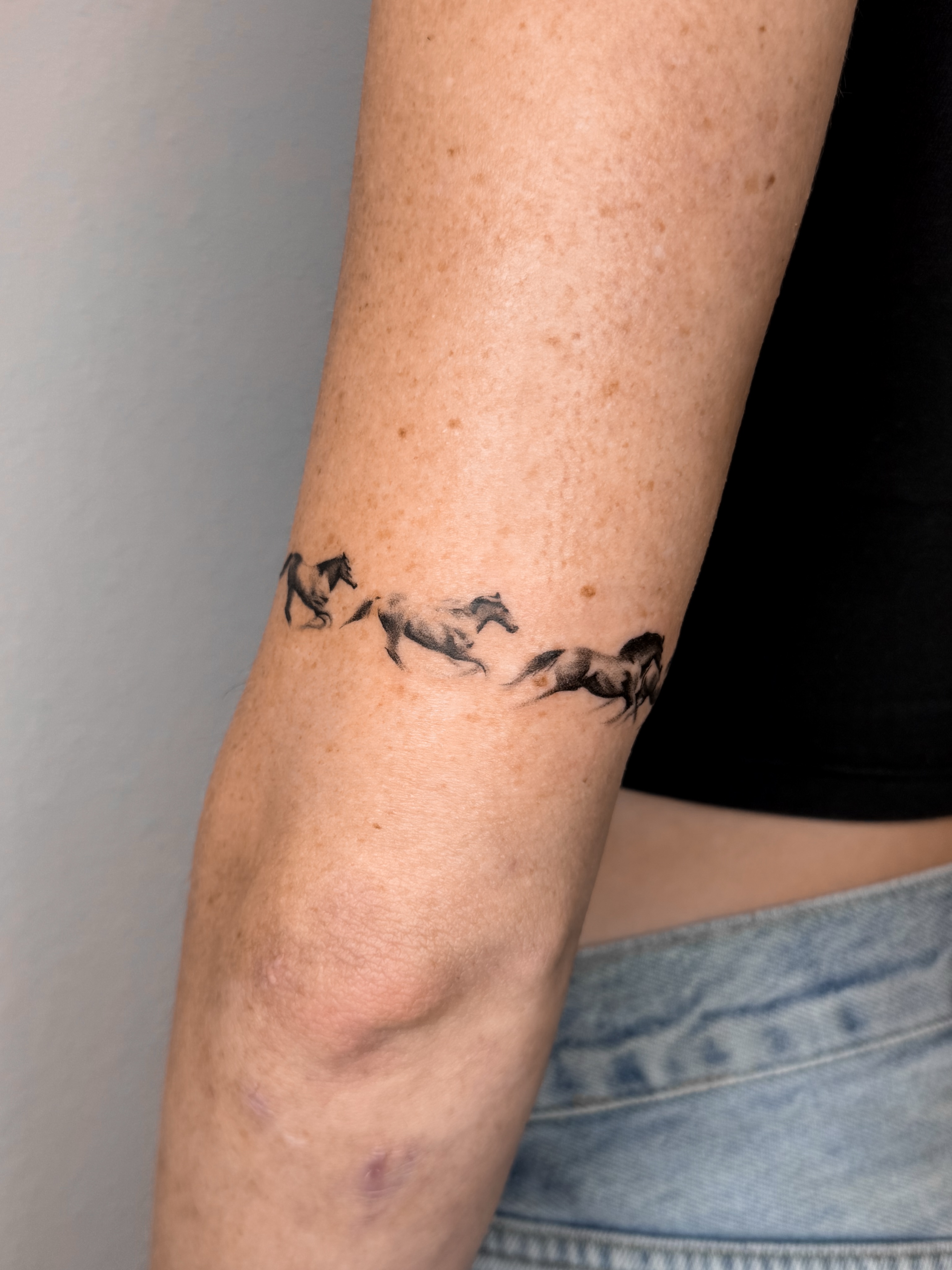 Horses black and grey tattoo on the forearm by Rylee