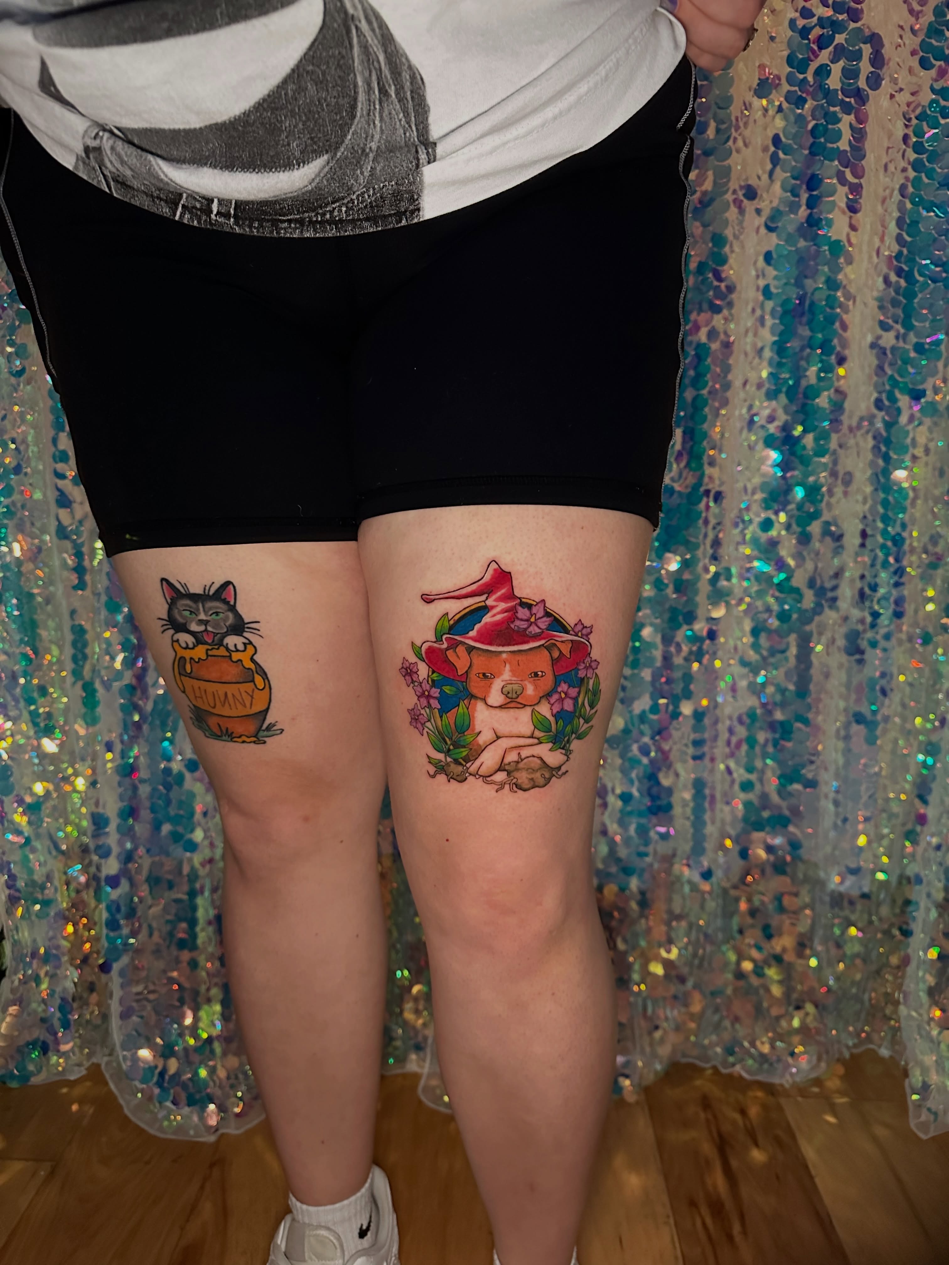 Cat and witch hat illustrative tattoo on the thigh by Sunny, Austin, Texas