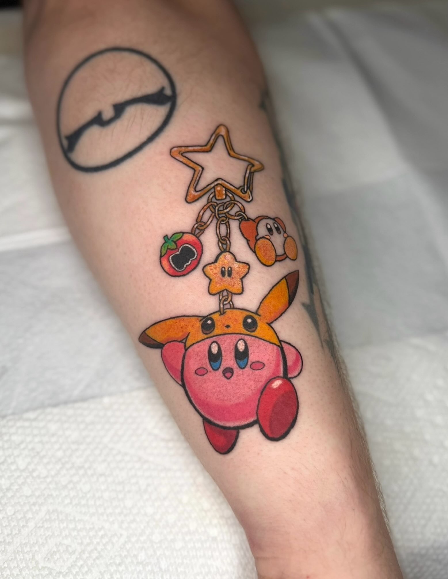 Kirby charm dotwork tattoo on the forearm by Brandi 🕷, Mentor, Ohio