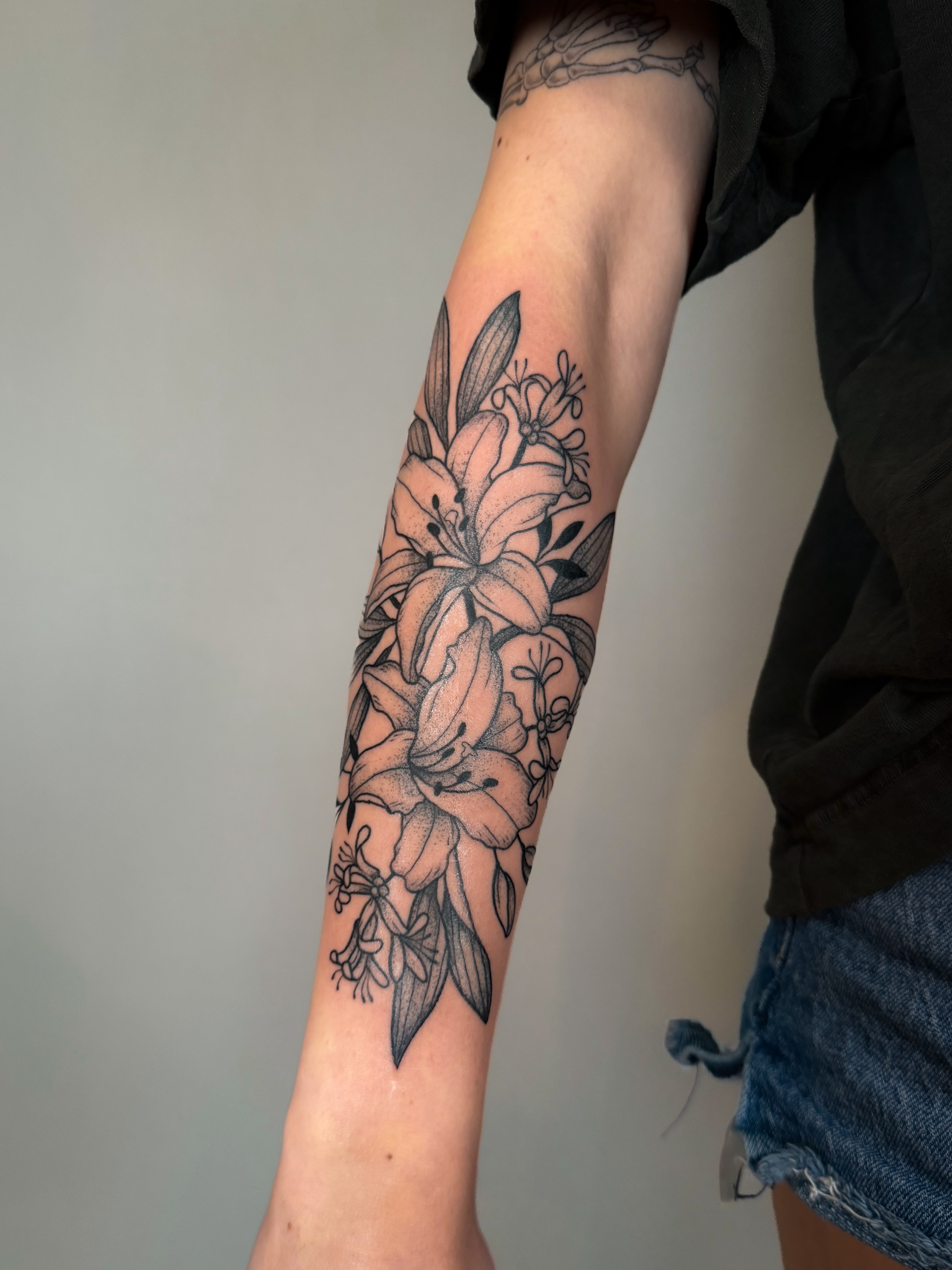 Lilies dotwork tattoo on the forearm by Hannah, Portland, Oregon