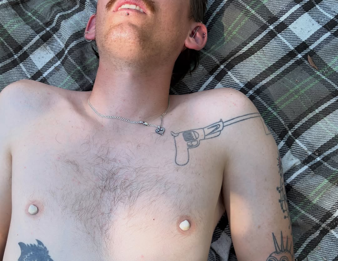 Gun black and grey tattoo on the chest by springgreens