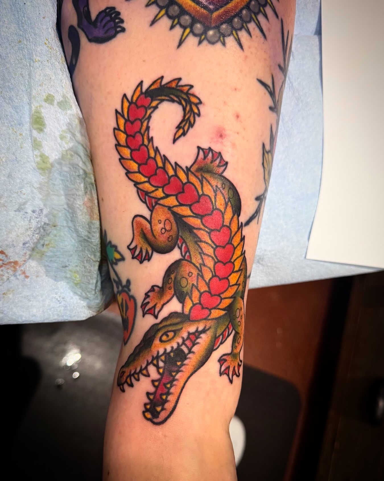 Alligator with hearts American traditional tattoo on the forearm by Cory Haberman