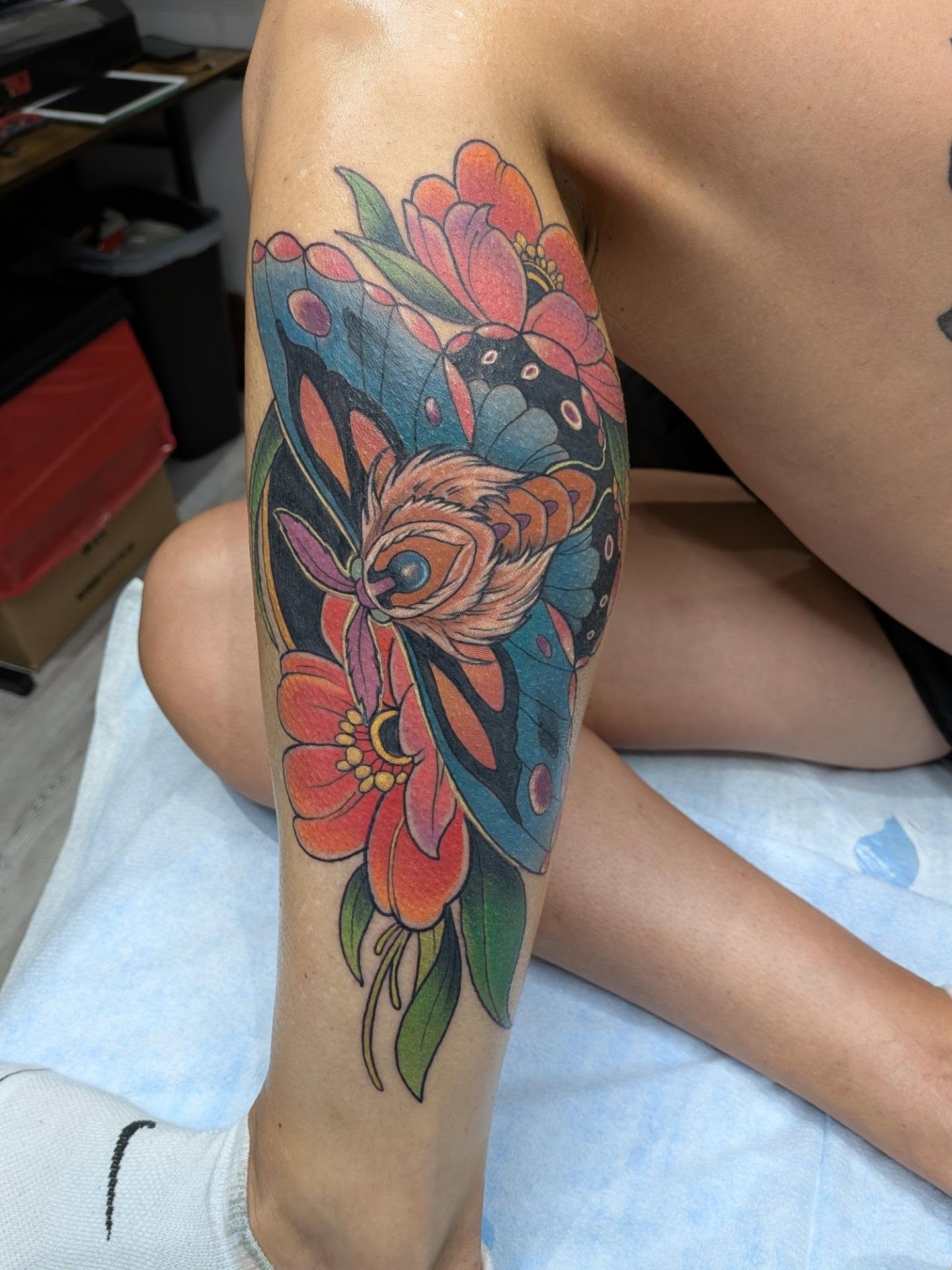 Butterfly and flowers new school tattoo on the forearm by Chris Bowen