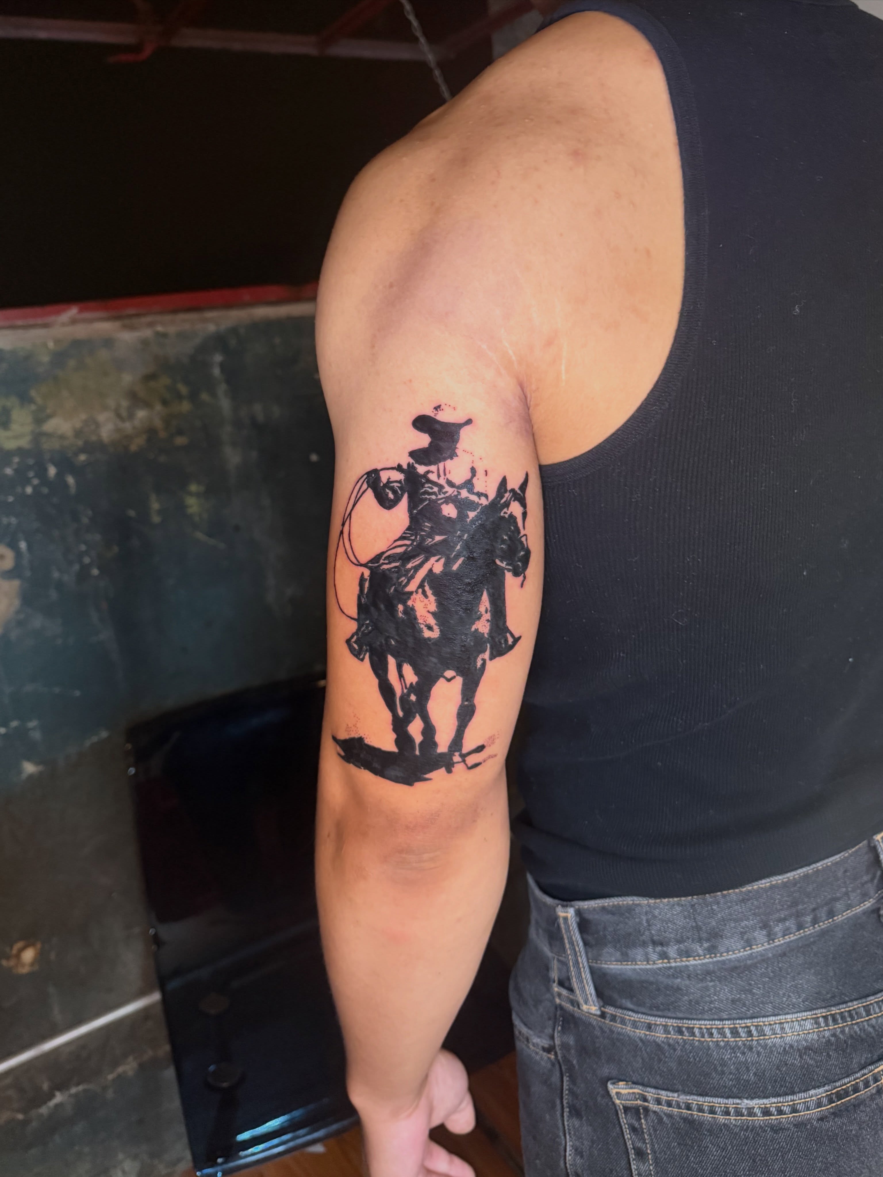 Cowboy on horse black and grey tattoo on the forearm by Jose Javier