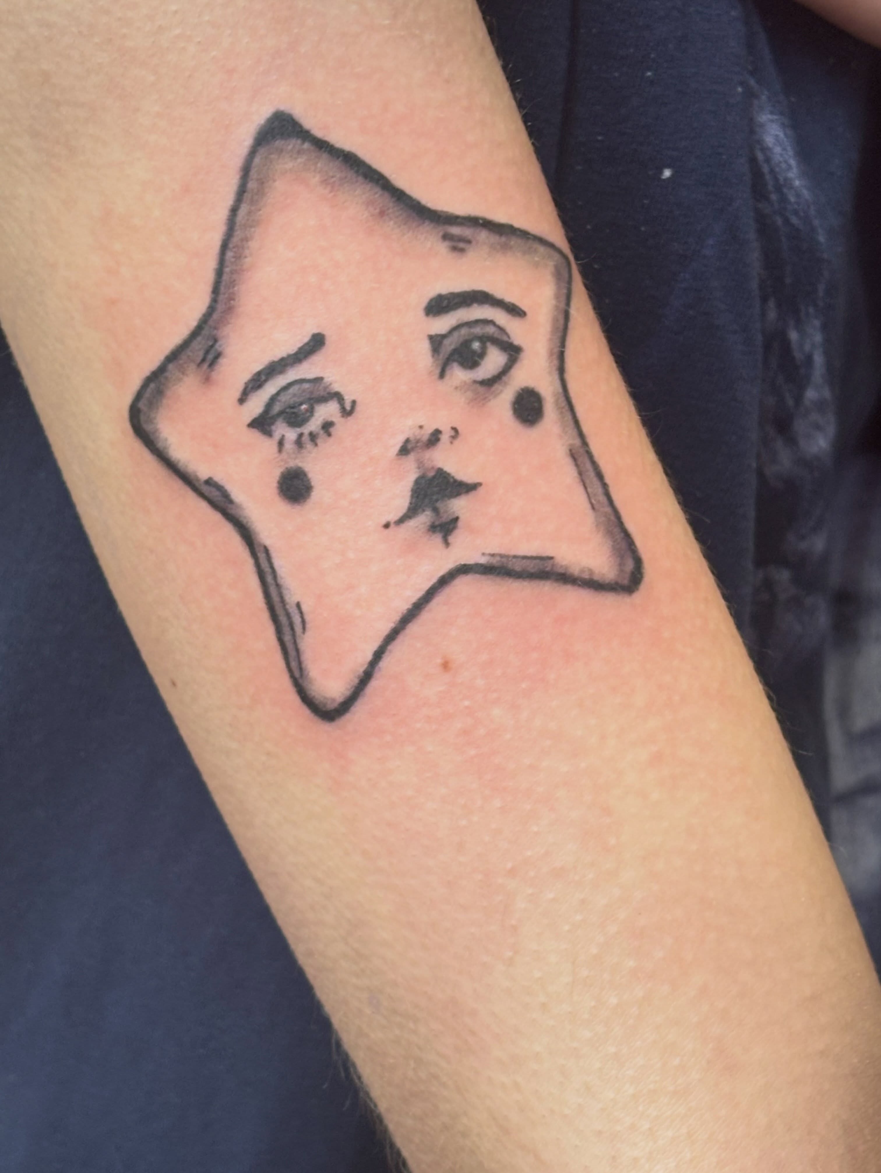 Abstract face geometric tattoo on the forearm by Natalie Jade Shupe