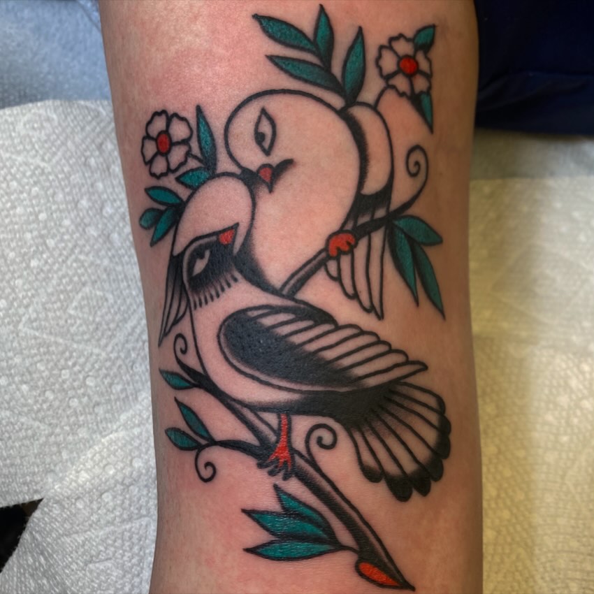 Doves and flowers American traditional tattoo on the forearm by Abby Rose Estes