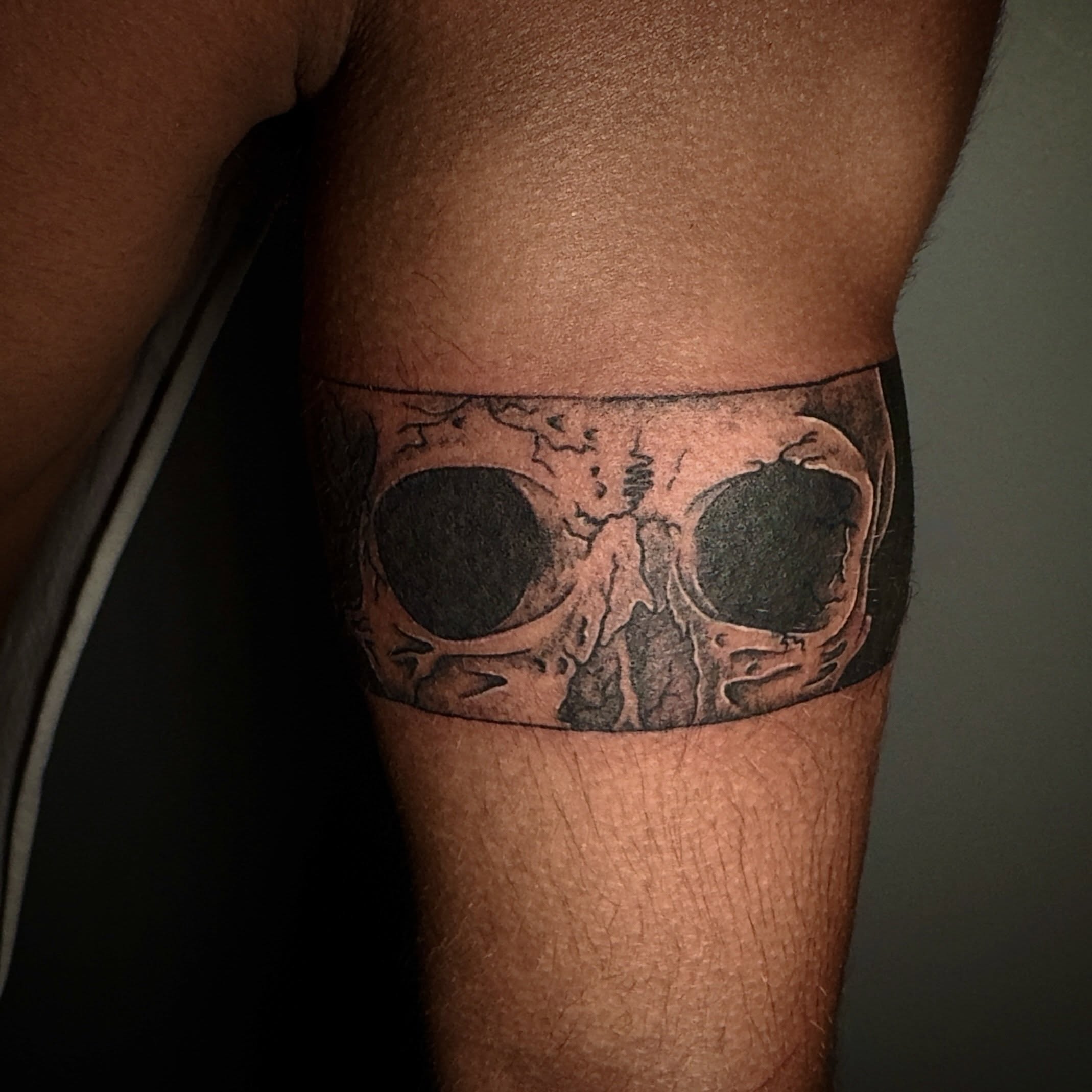 Skull black and grey tattoo on the forearm by Seth Christianson