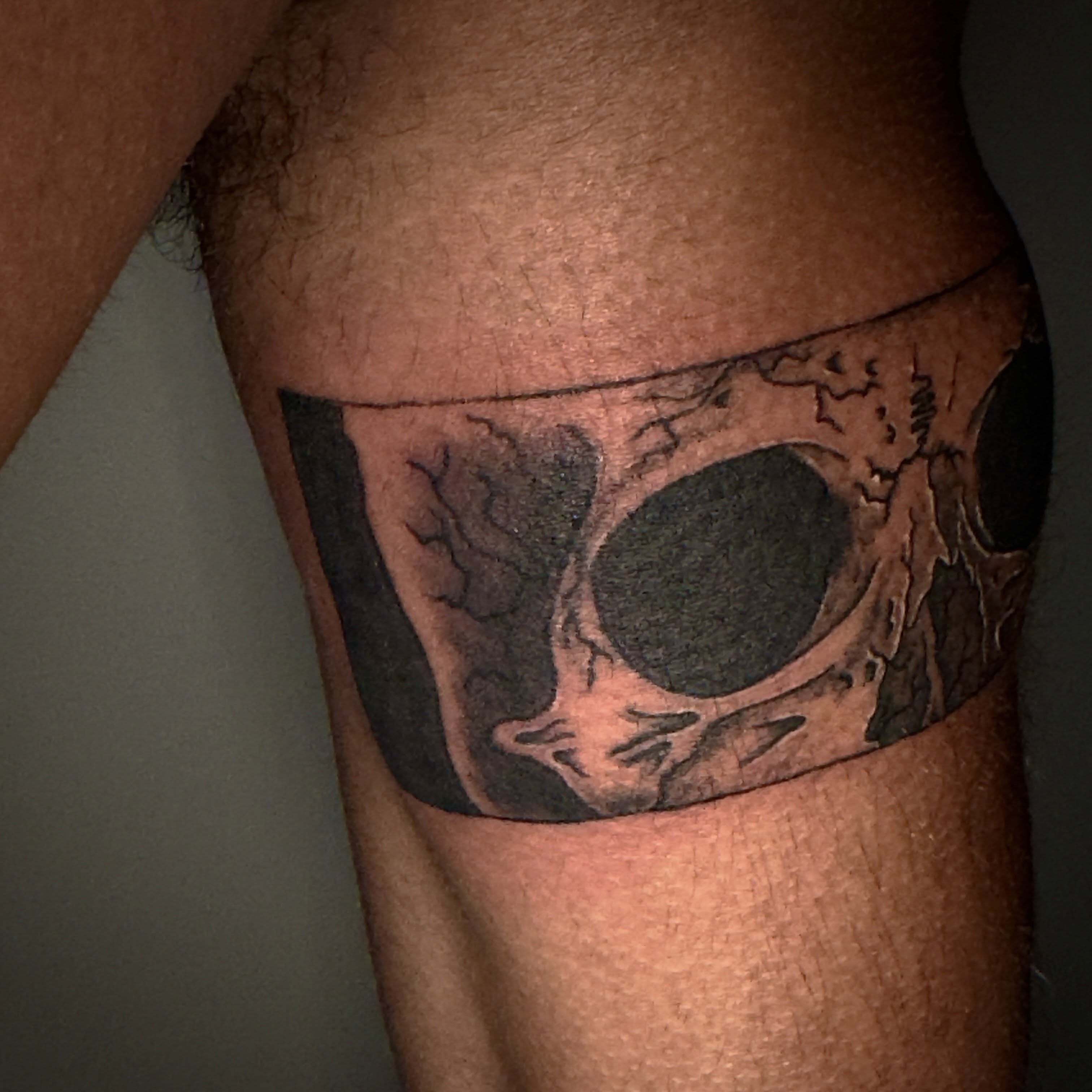 Eye black and grey tattoo on the thigh by Seth Christianson