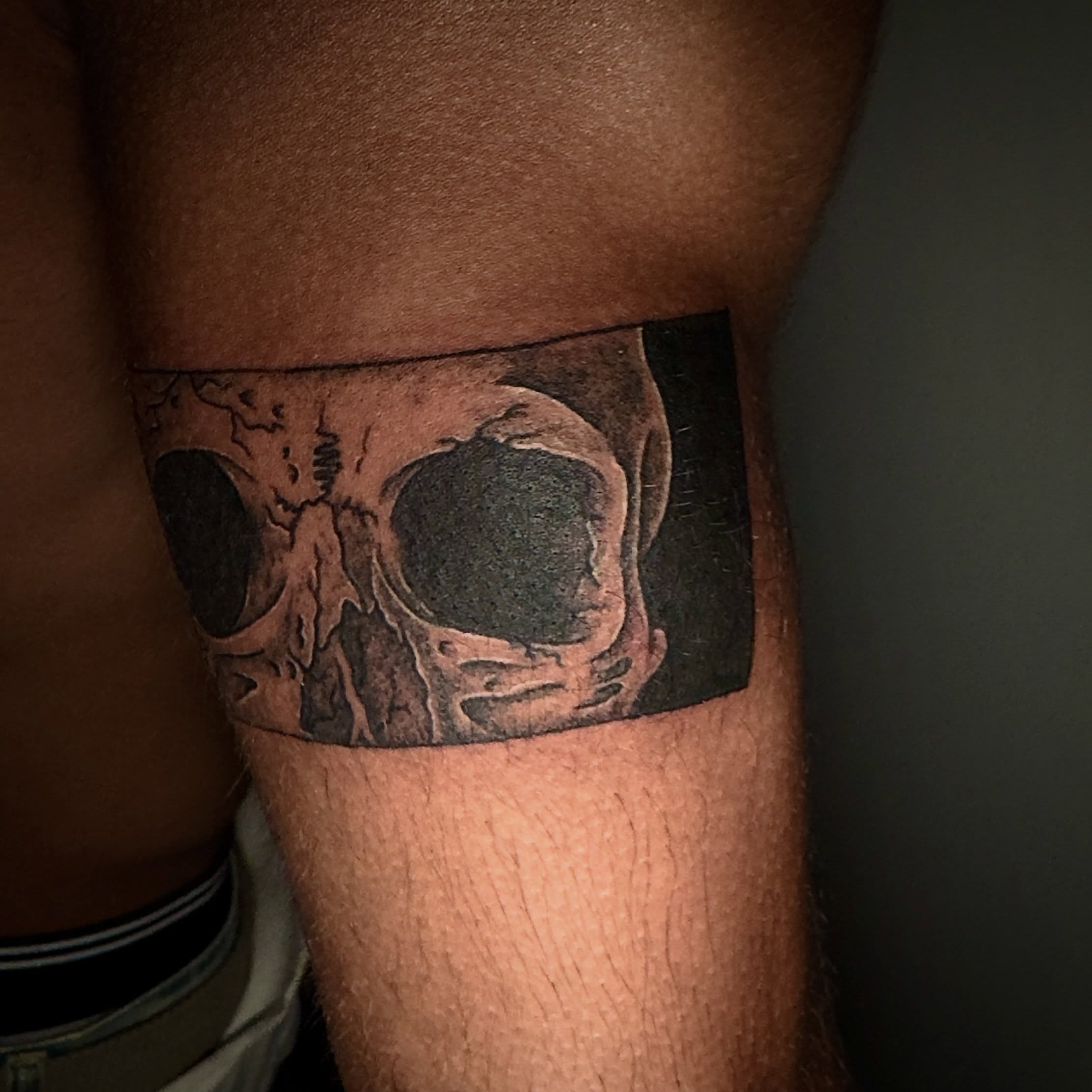Skull black and grey tattoo on the thigh by Seth Christianson