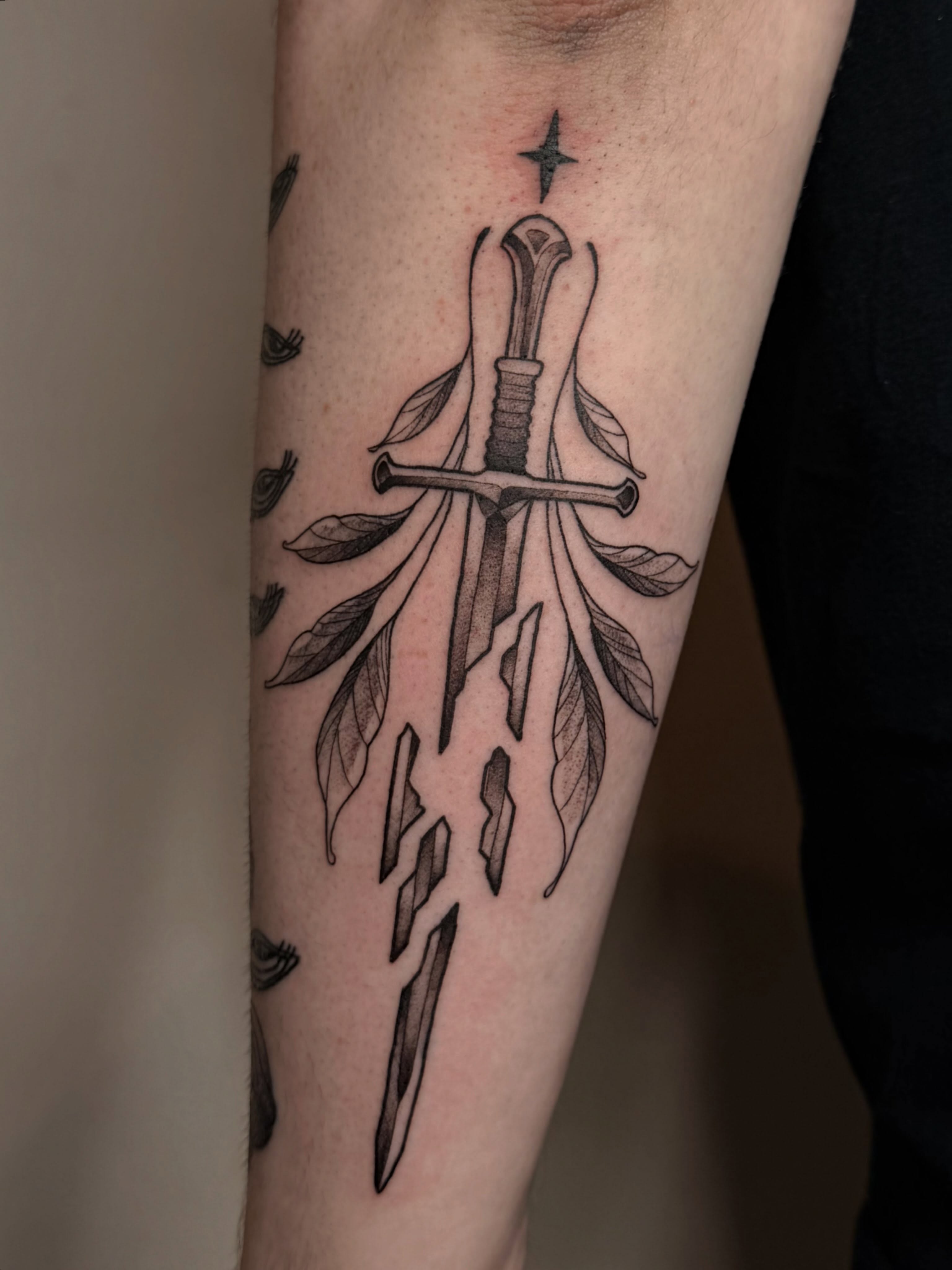 Sword and leaves black and grey tattoo on the forearm by Destiny Illustration