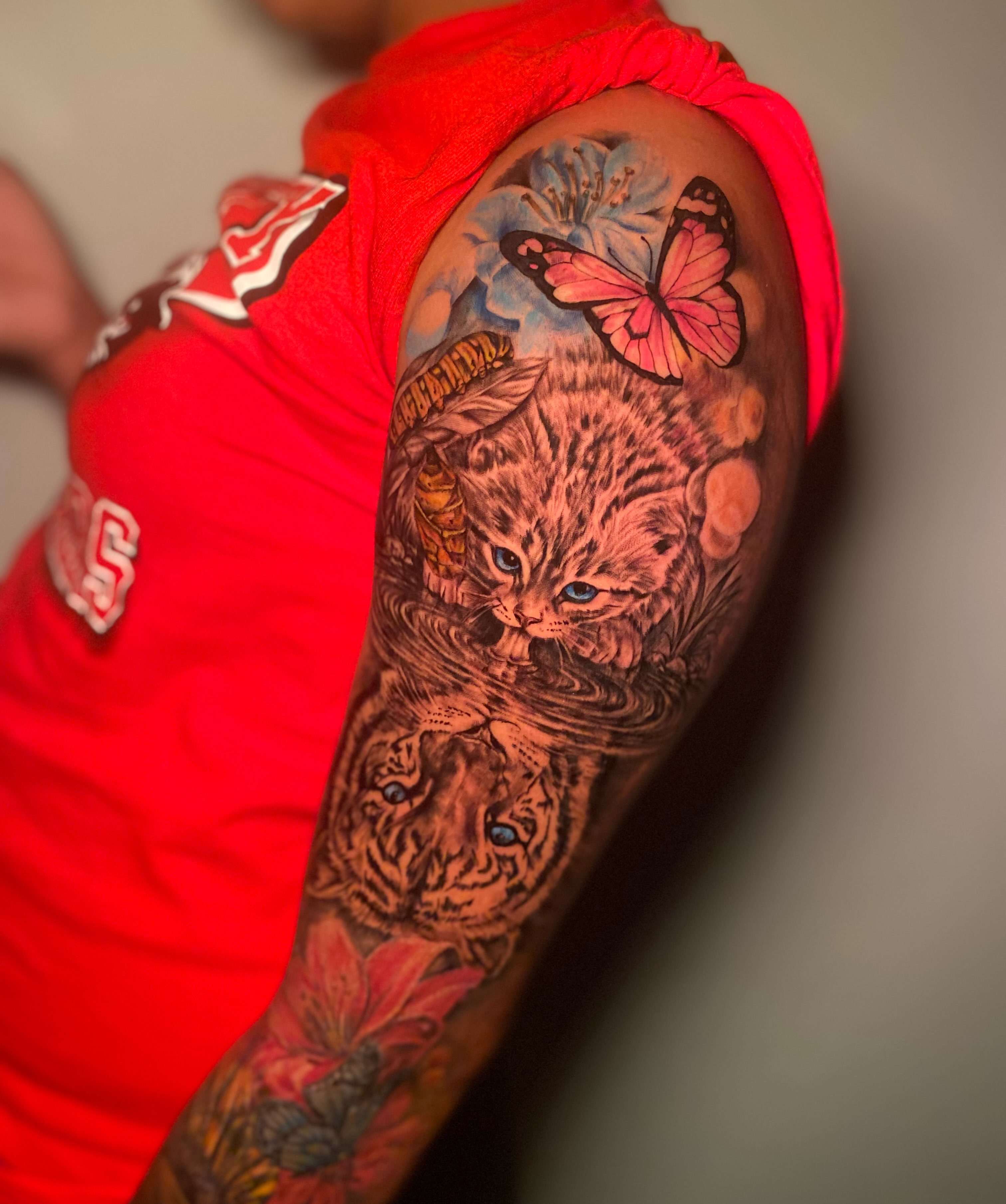Cat and butterfly realism tattoo on the forearm by Tattoo Artist