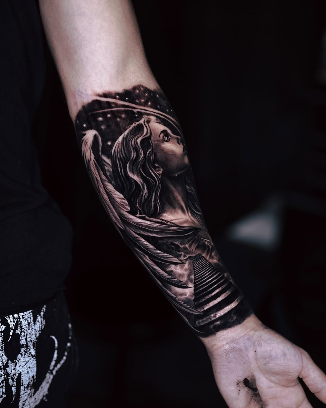 Angelic figure realism tattoo on the forearm by Marcos Salamanca
