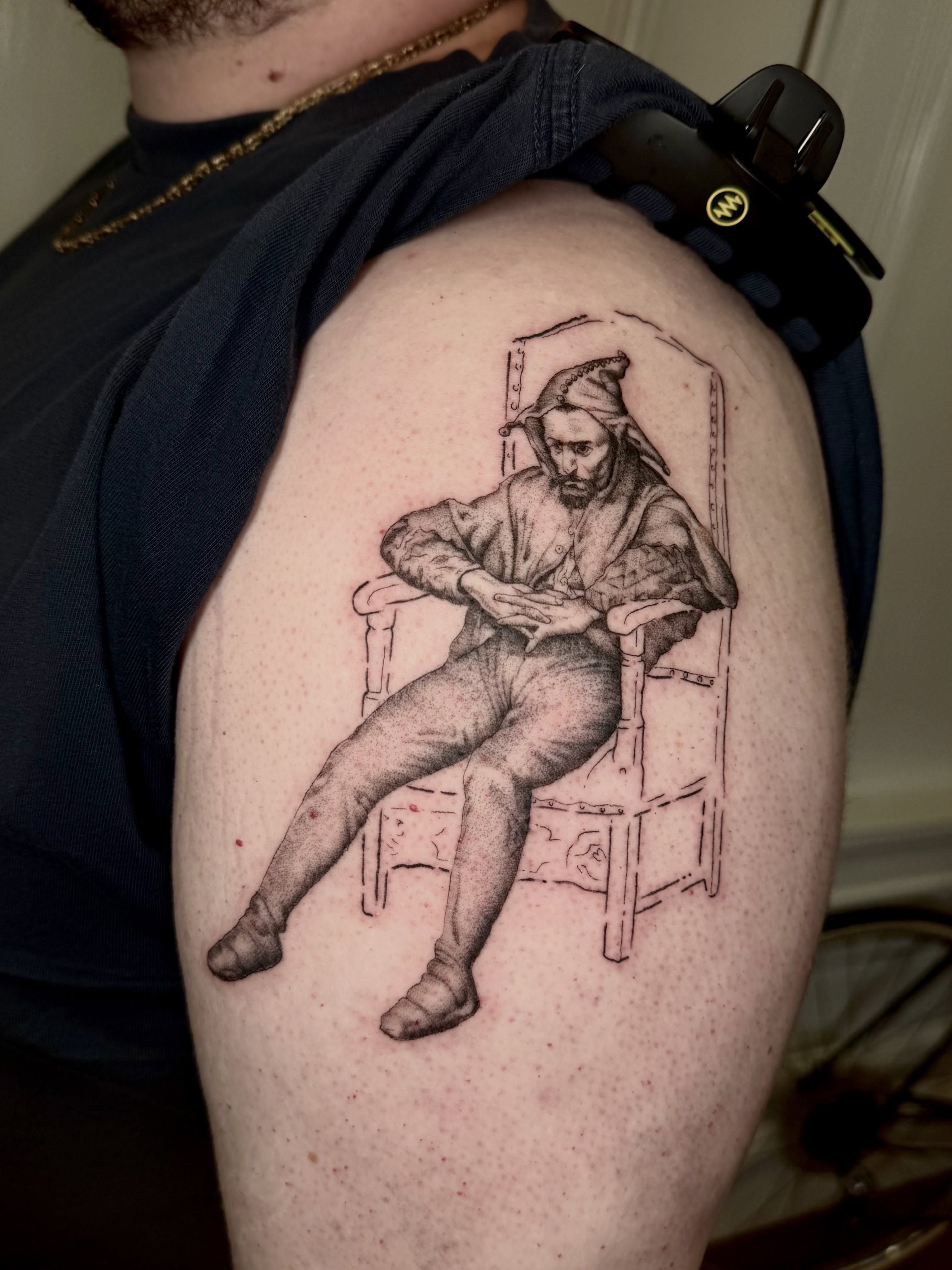 Man sitting black and grey tattoo on the shoulder by Ian Saner