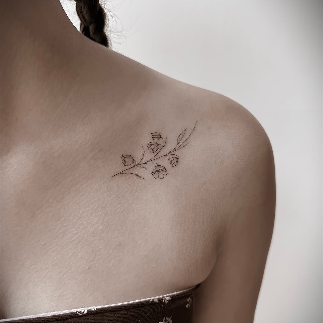 Flower bouquet fine line tattoo on the shoulder by Chanel Picquelle, Nashville, Tennessee