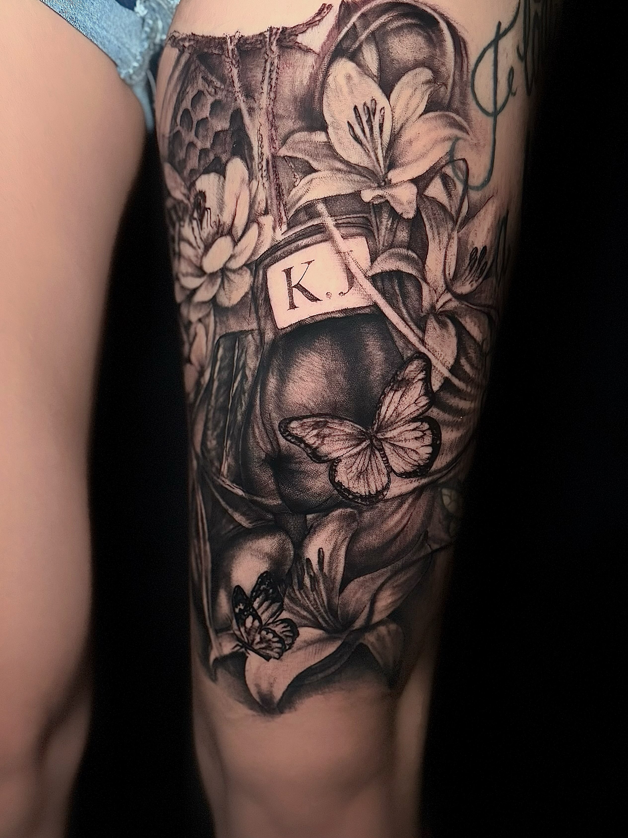 Lilies and butterfly realism tattoo on the forearm by Jocelyn