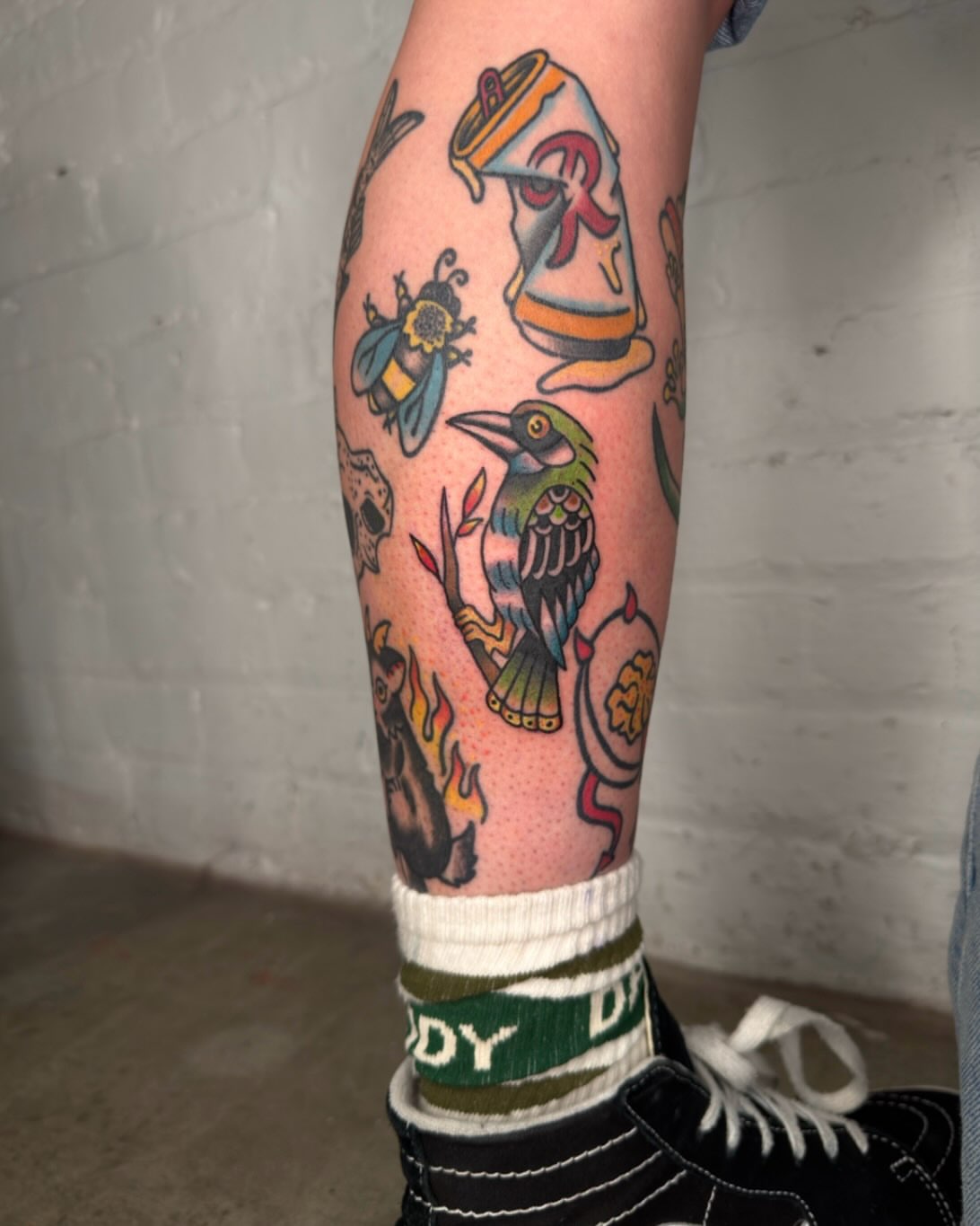 Bird and bee American traditional tattoo on the forearm by Dennis Patterson