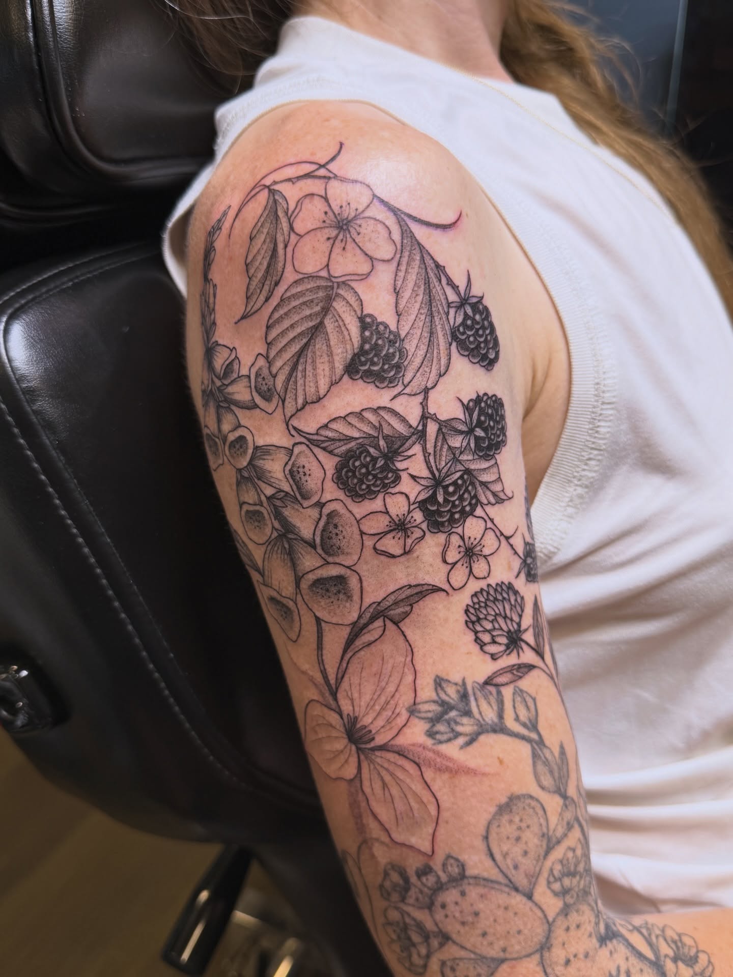 Floral arrangement black and grey tattoo on the upper arm by WhoisLaineyTattoos