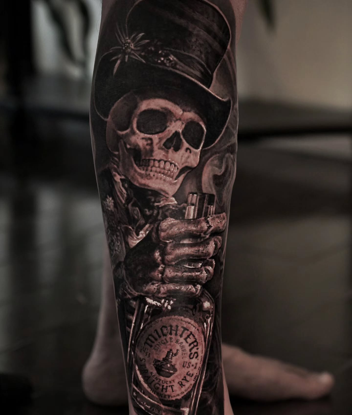 Skull wearing top hat realism tattoo on the calf by Owen Paulls