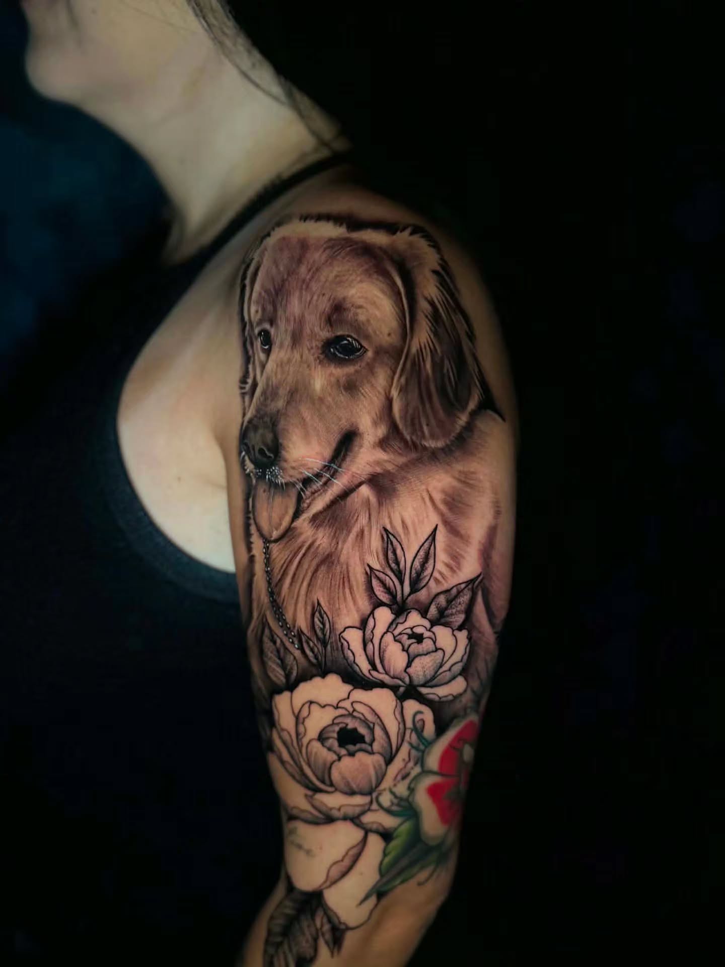 Dog and flowers realism tattoo on the shoulder by Jon Goad