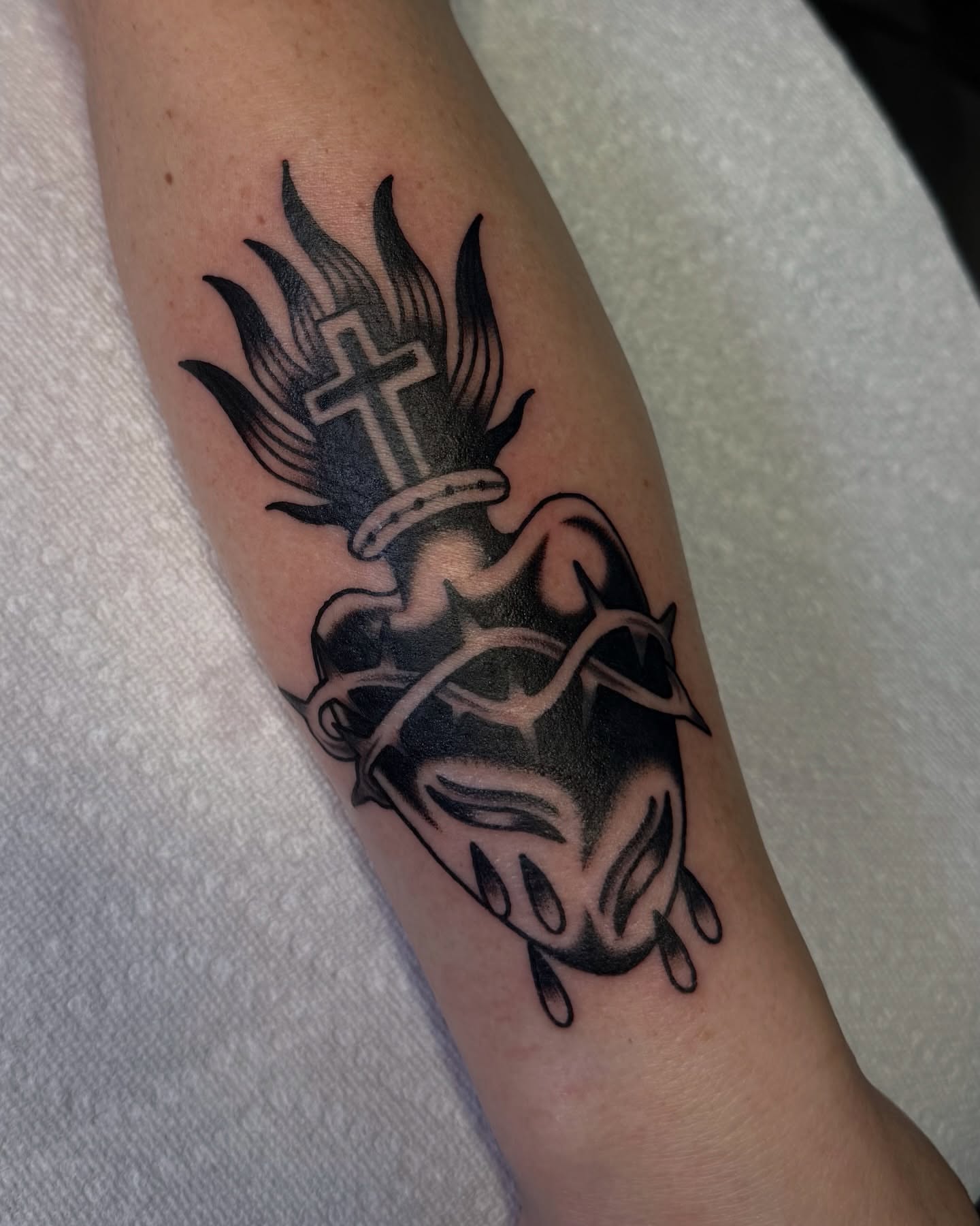 Heart with cross and flames black and grey tattoo on the forearm by ＊ Carly James ＊