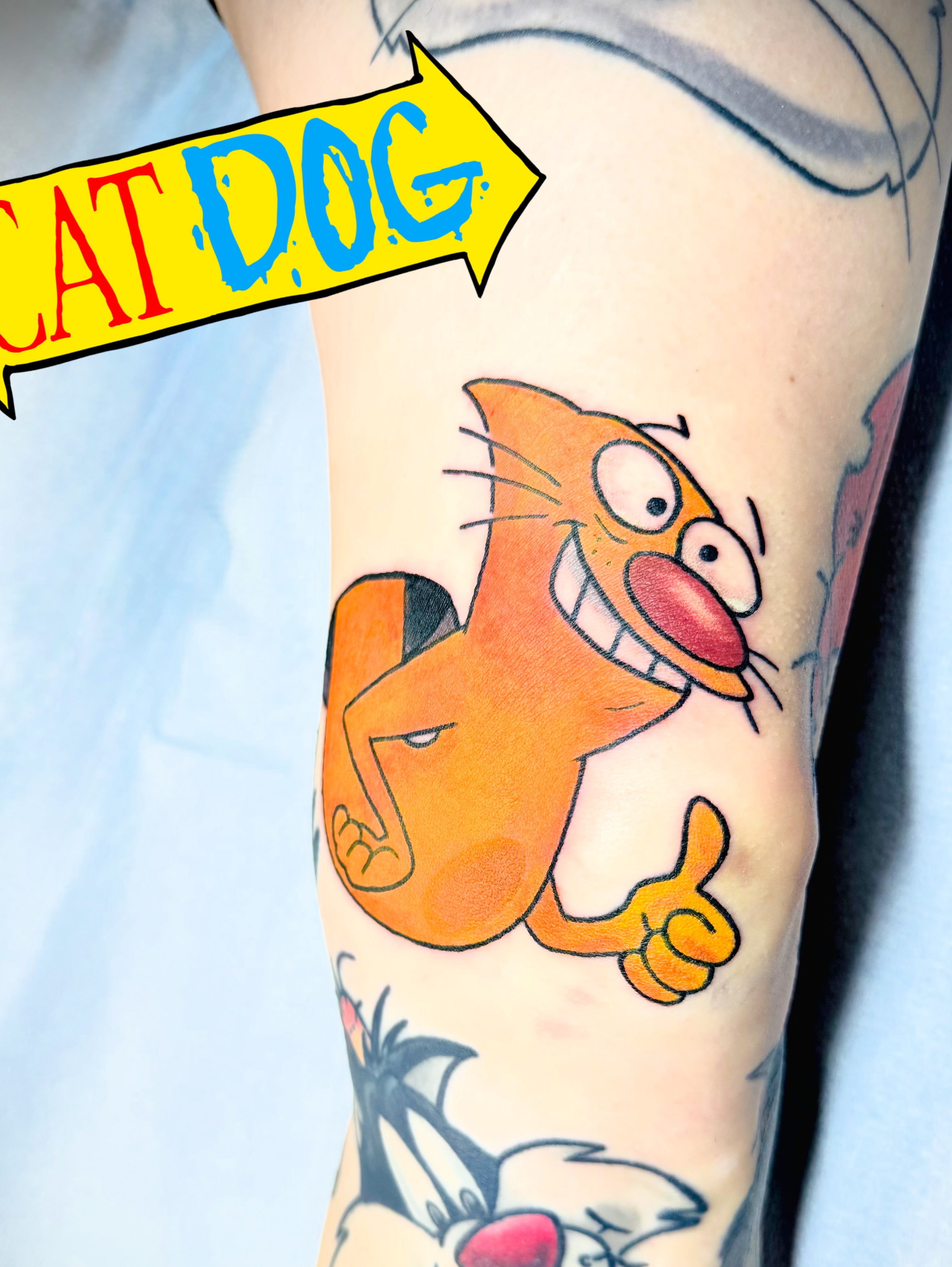 Cat dog American traditional tattoo on the forearm by San Diego Tattoo Artist