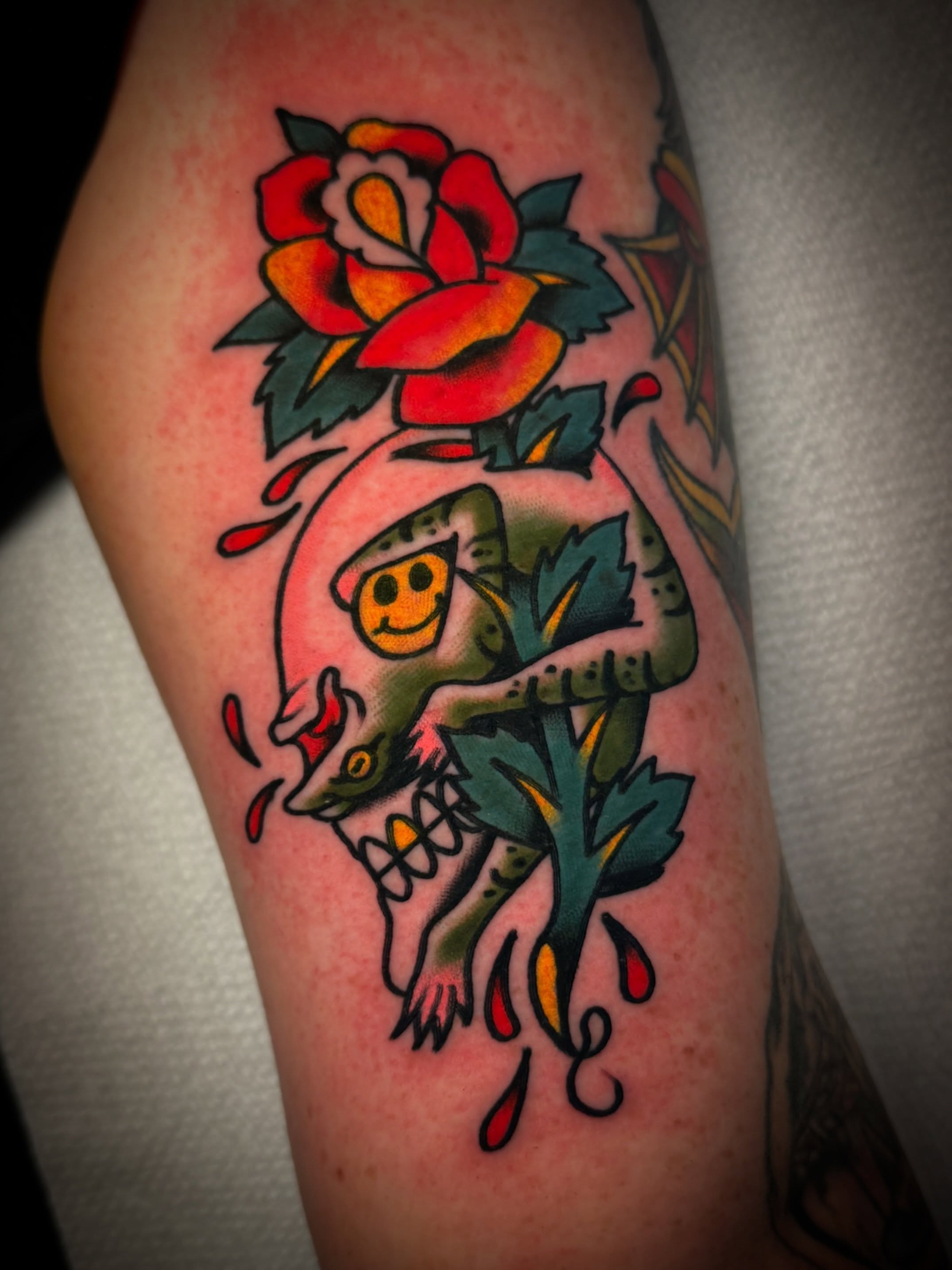 Snake and rose American traditional tattoo on the forearm by Dave Osrowitz