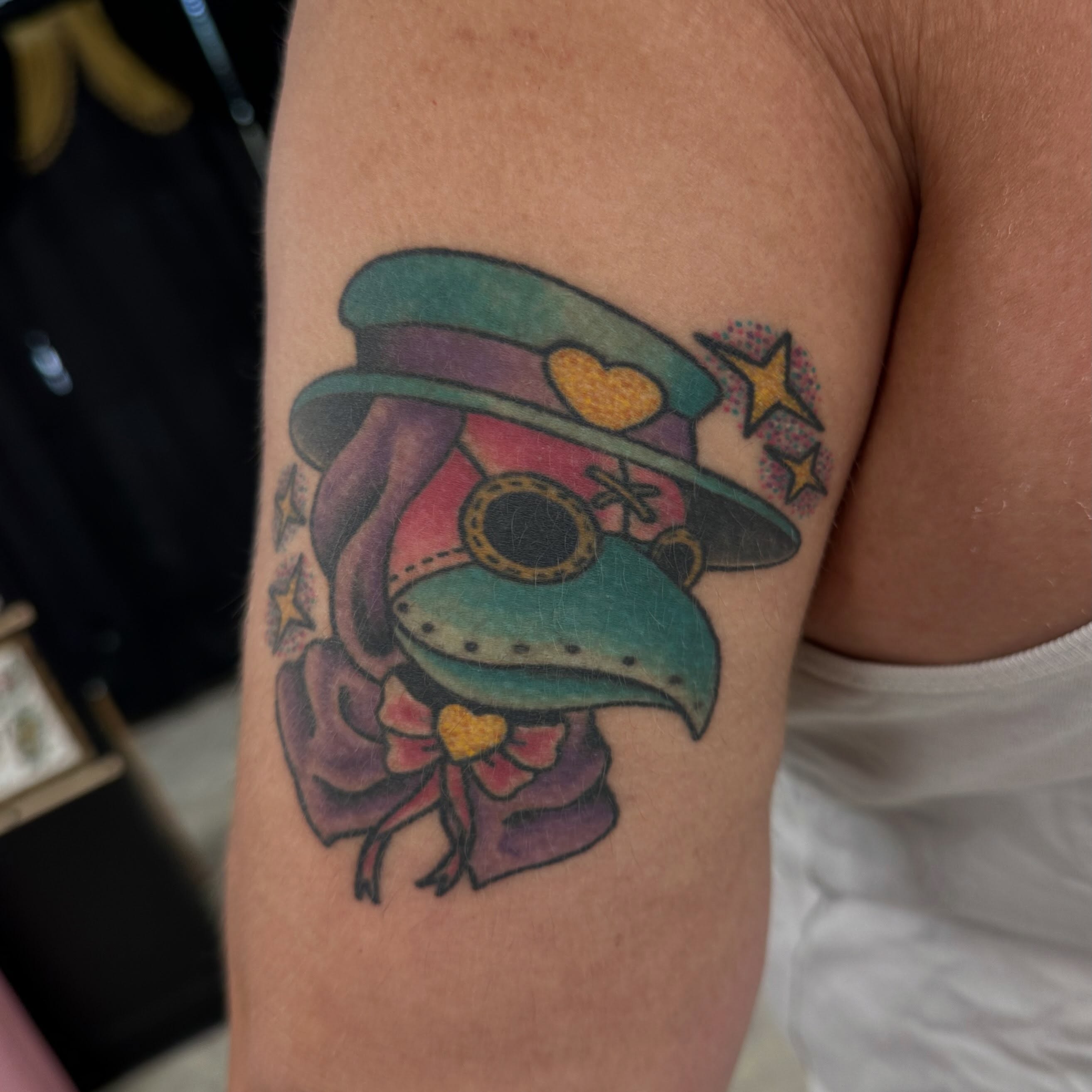 Hat and bird new school tattoo on the forearm by Nicki Hoverson