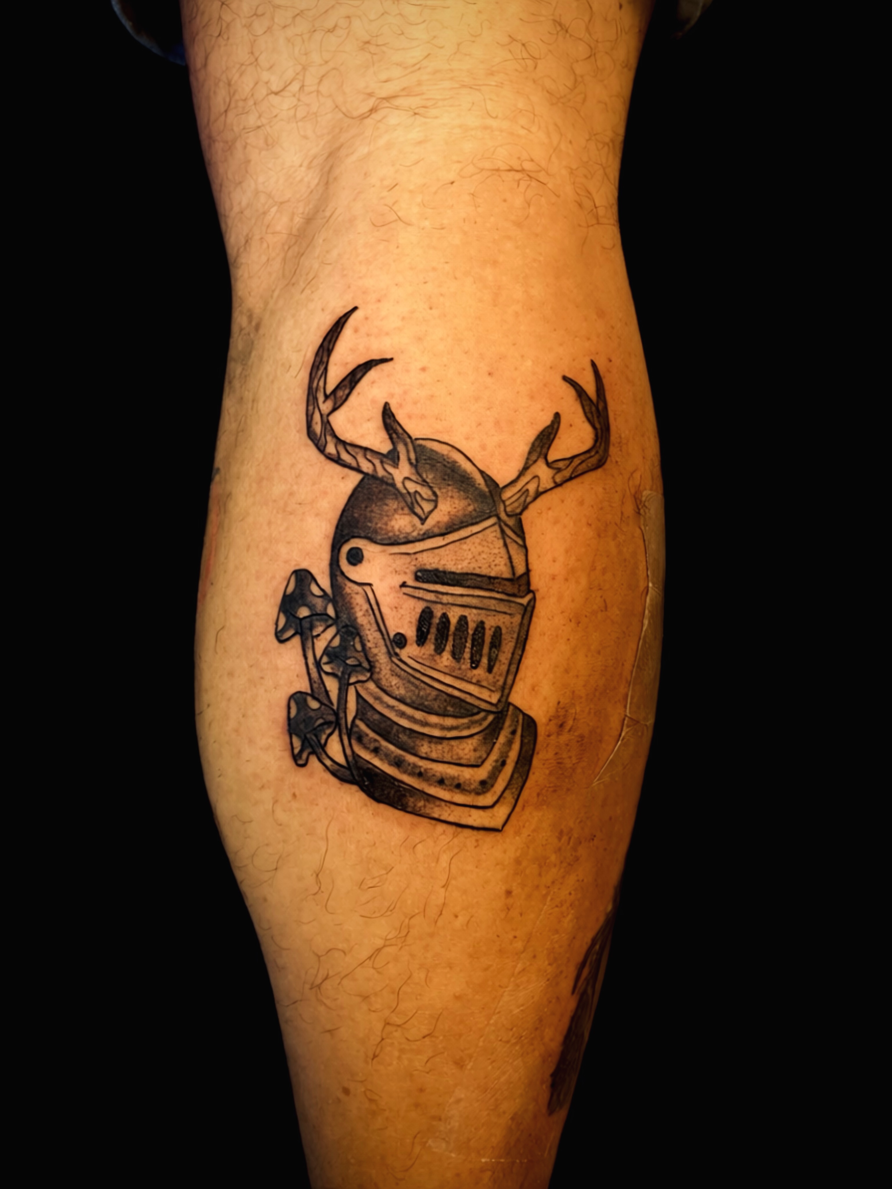 Antlered knight helmet black and grey tattoo on the forearm by Shay Cole