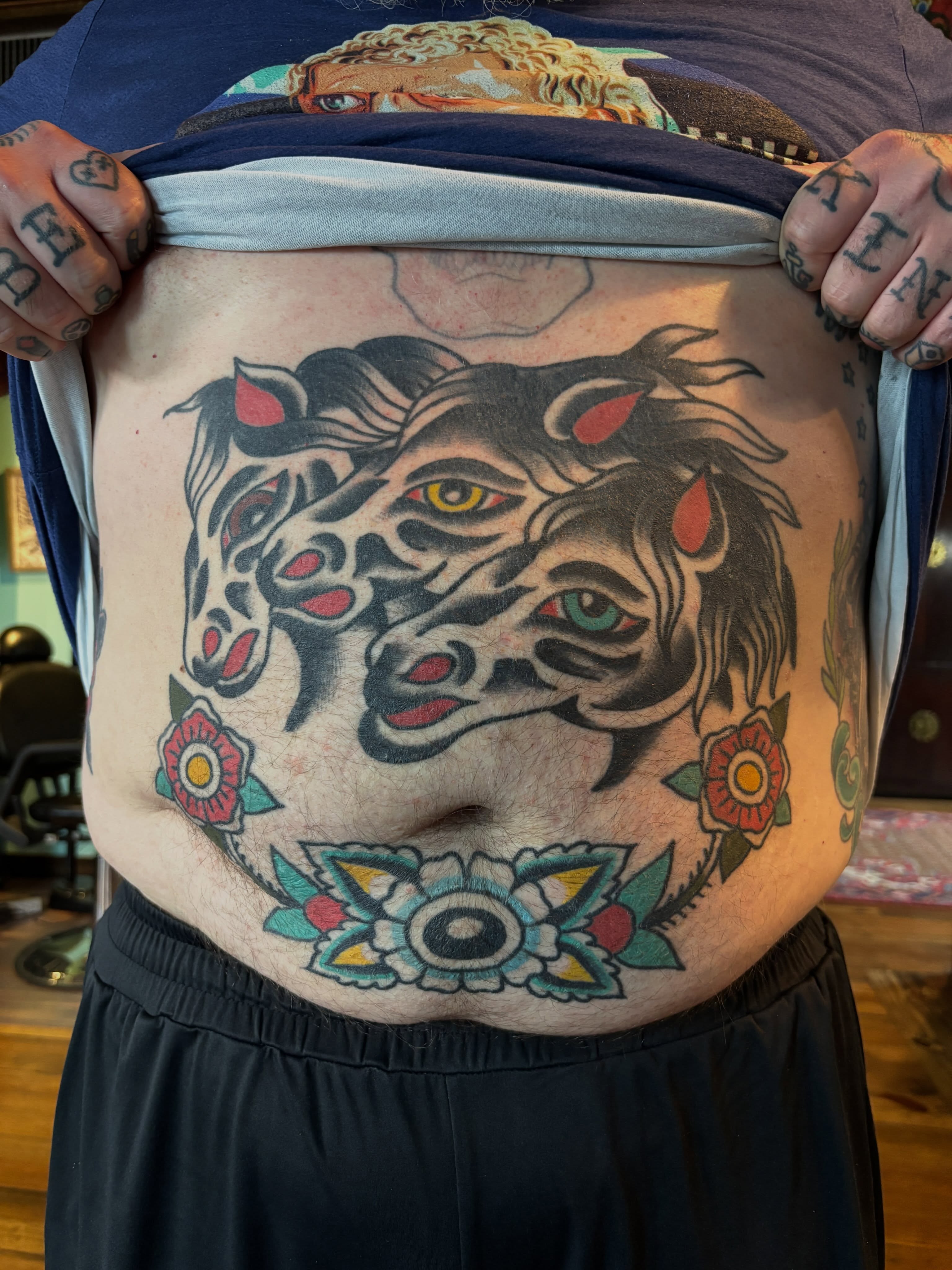 Tiger and floral American traditional tattoo on the torso by Mitch Ashpaugh