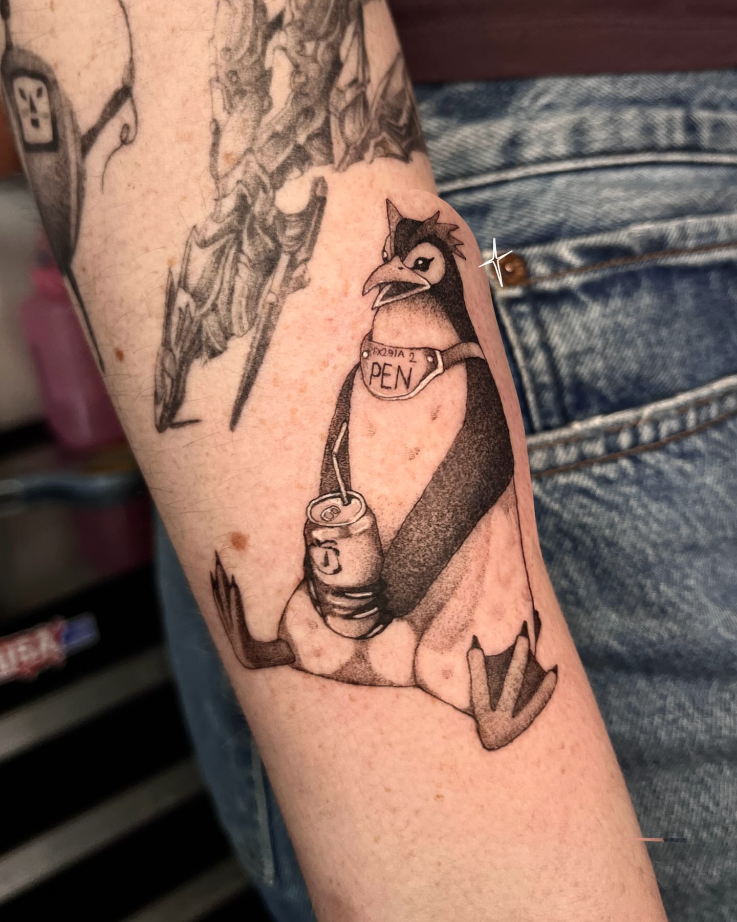 Owl with soda can black and grey tattoo on the forearm by Sarah Jurgielewicz