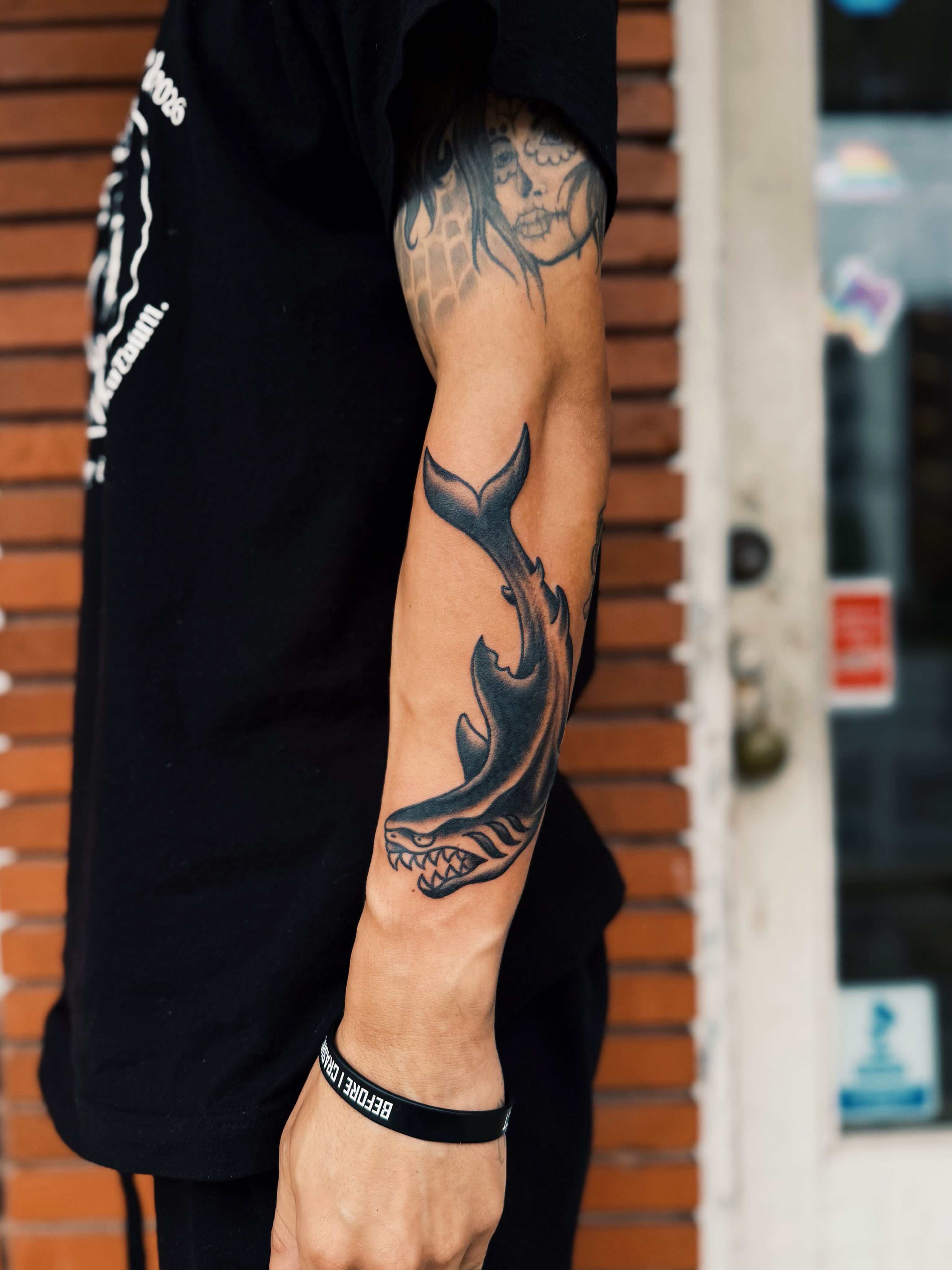 Shark black and grey tattoo on the forearm by @amandahowtattoo