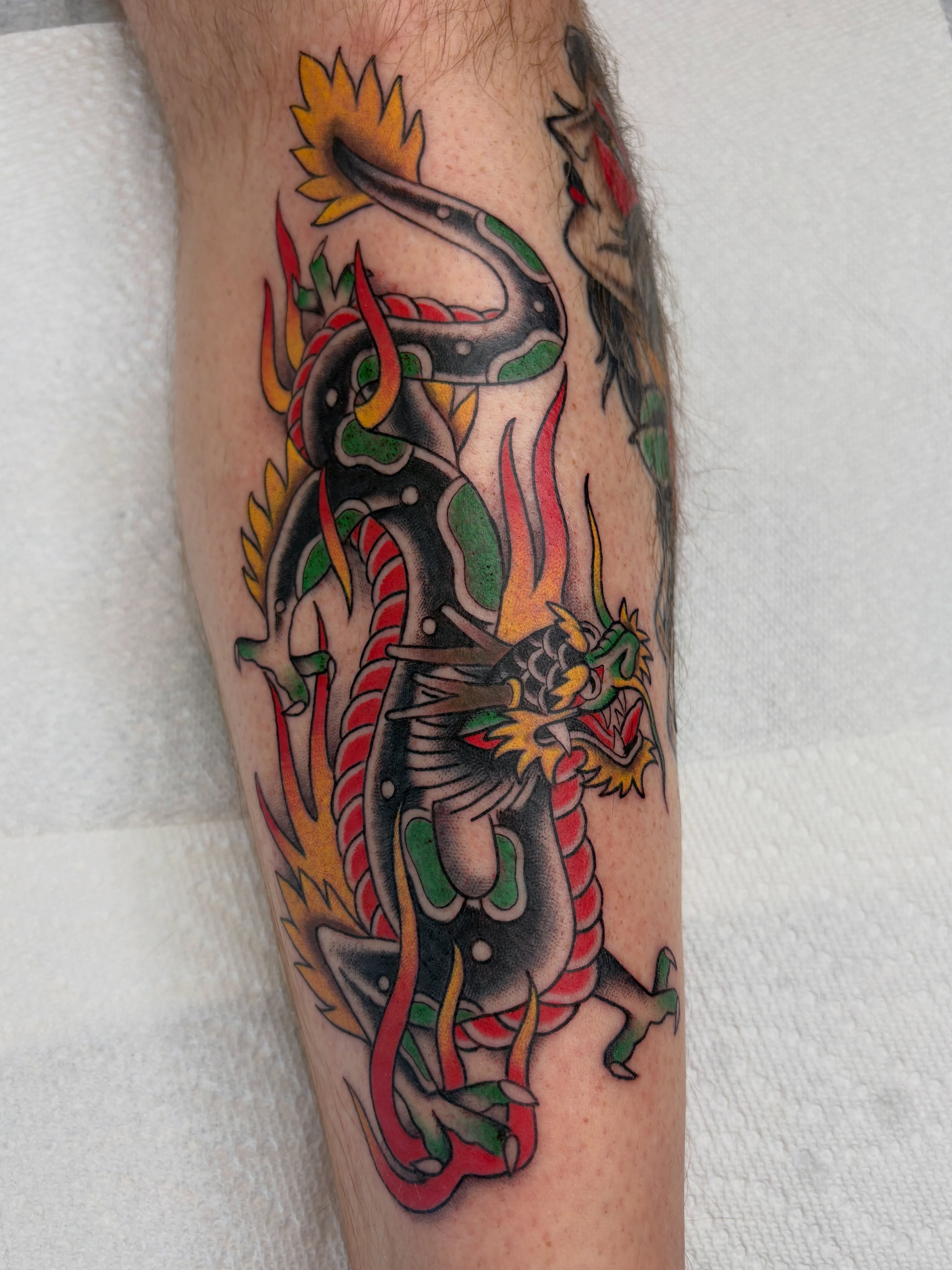 Dragon American traditional tattoo on the forearm by Josh Johns