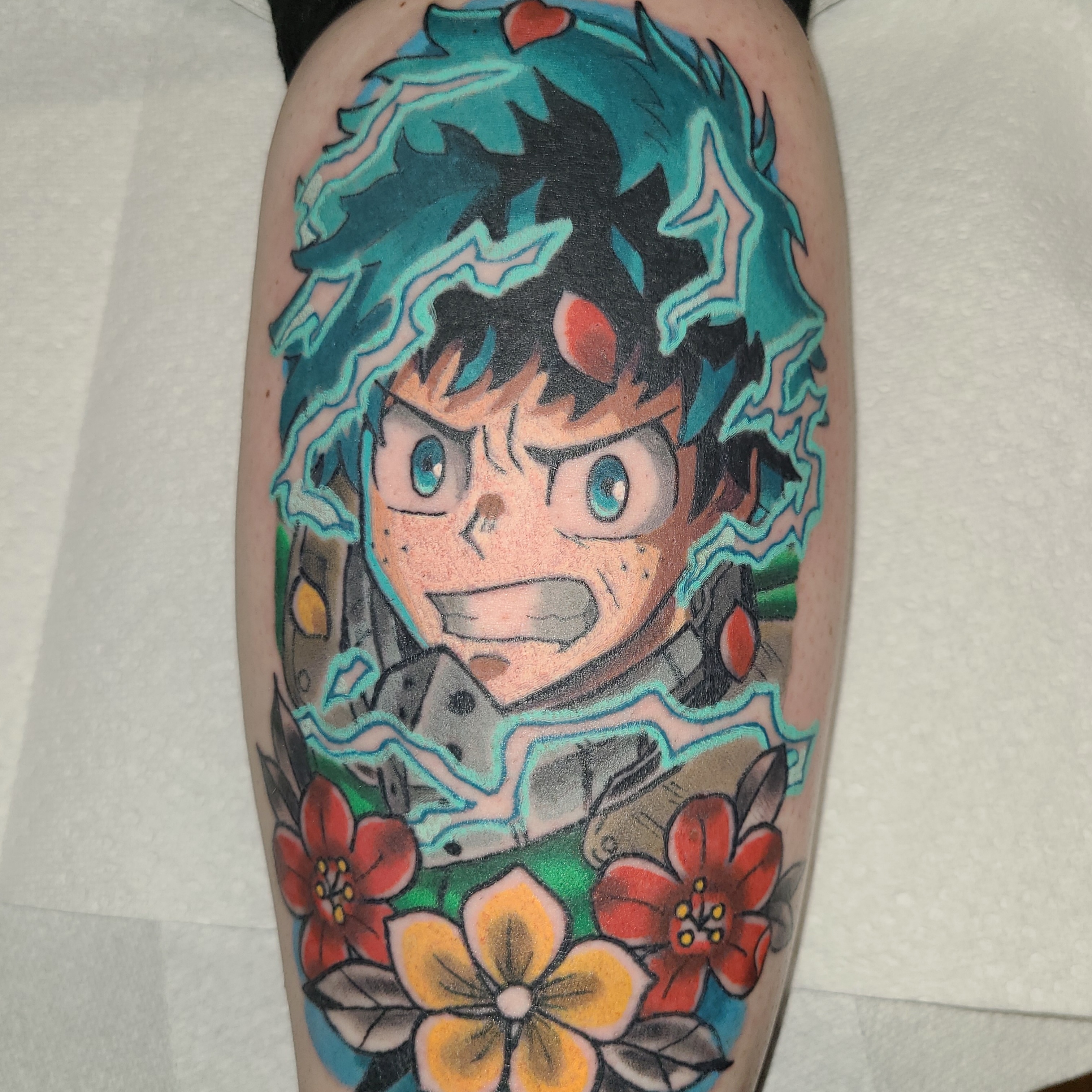 Anime character with flowers anime tattoo on the leg by Christopher Anderson-arnesen