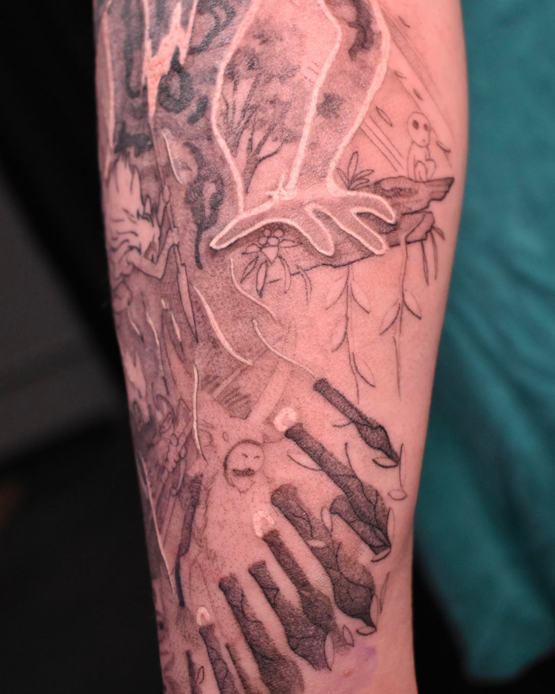 Bird and floral black and grey tattoo on the forearm by Erin Isaacs