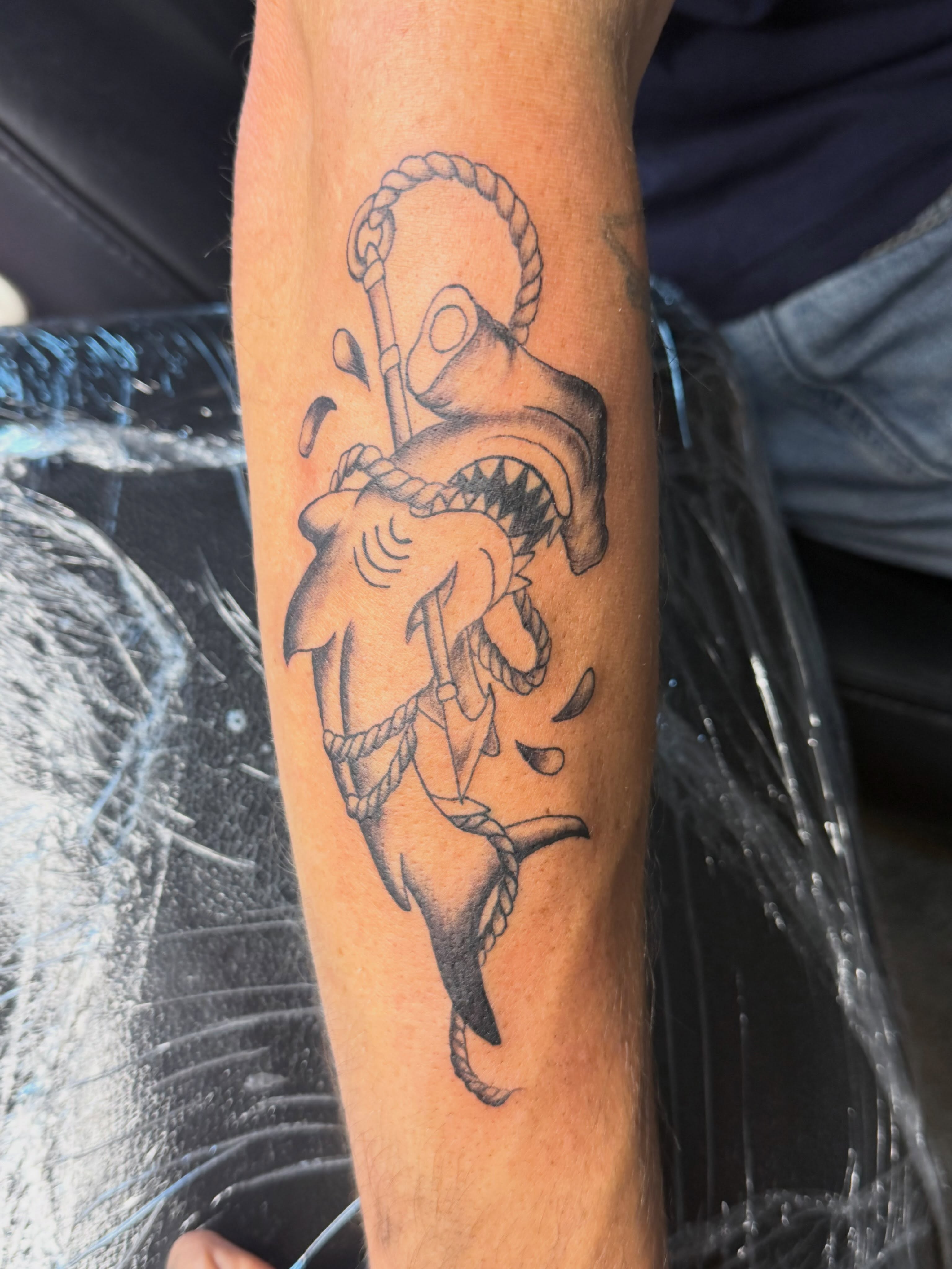 Shark with anchor black and grey tattoo on the forearm by Sonia vidal