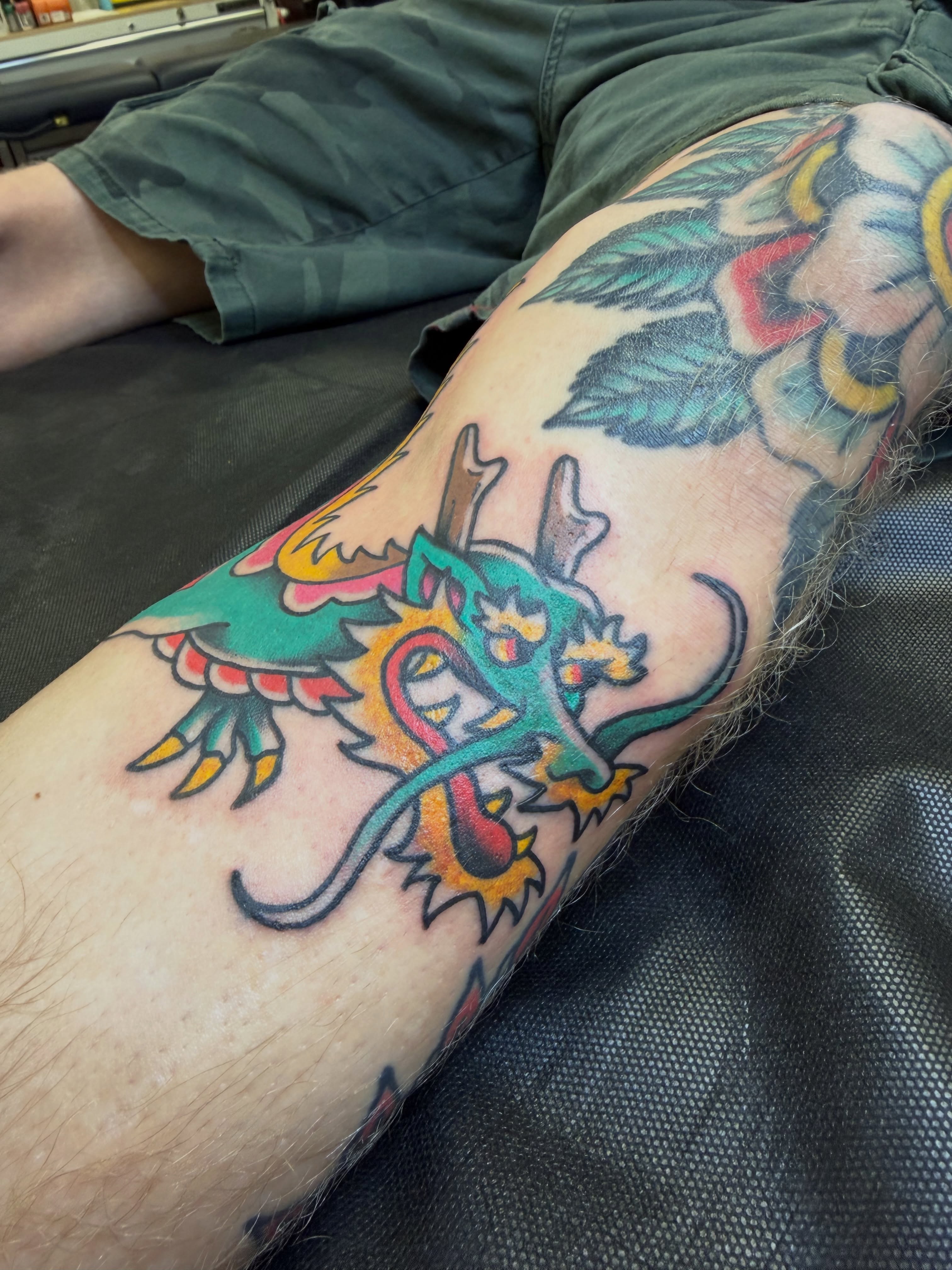 Dragon American traditional tattoo on the thigh by Nick Tumminello